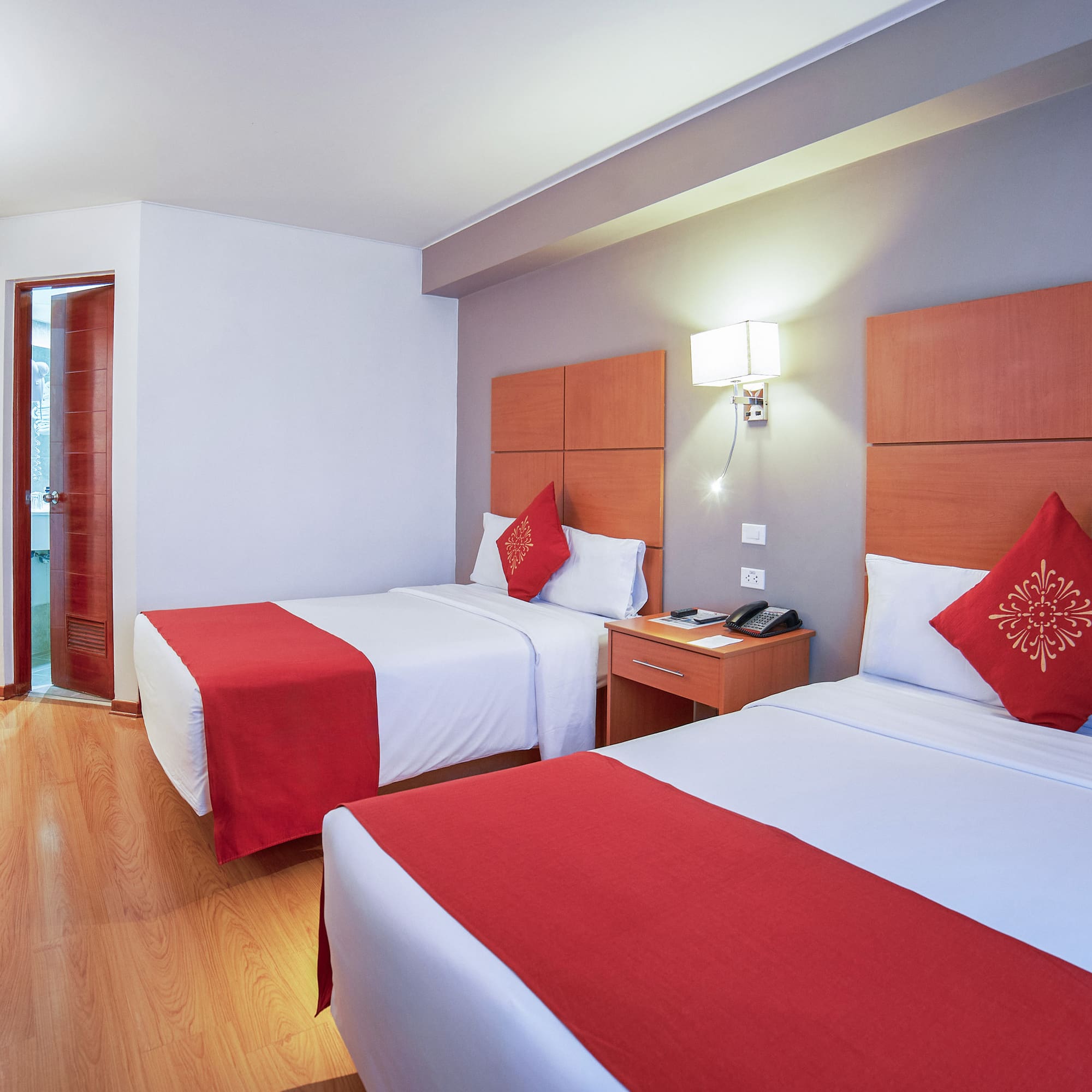 a room with two beds and a door