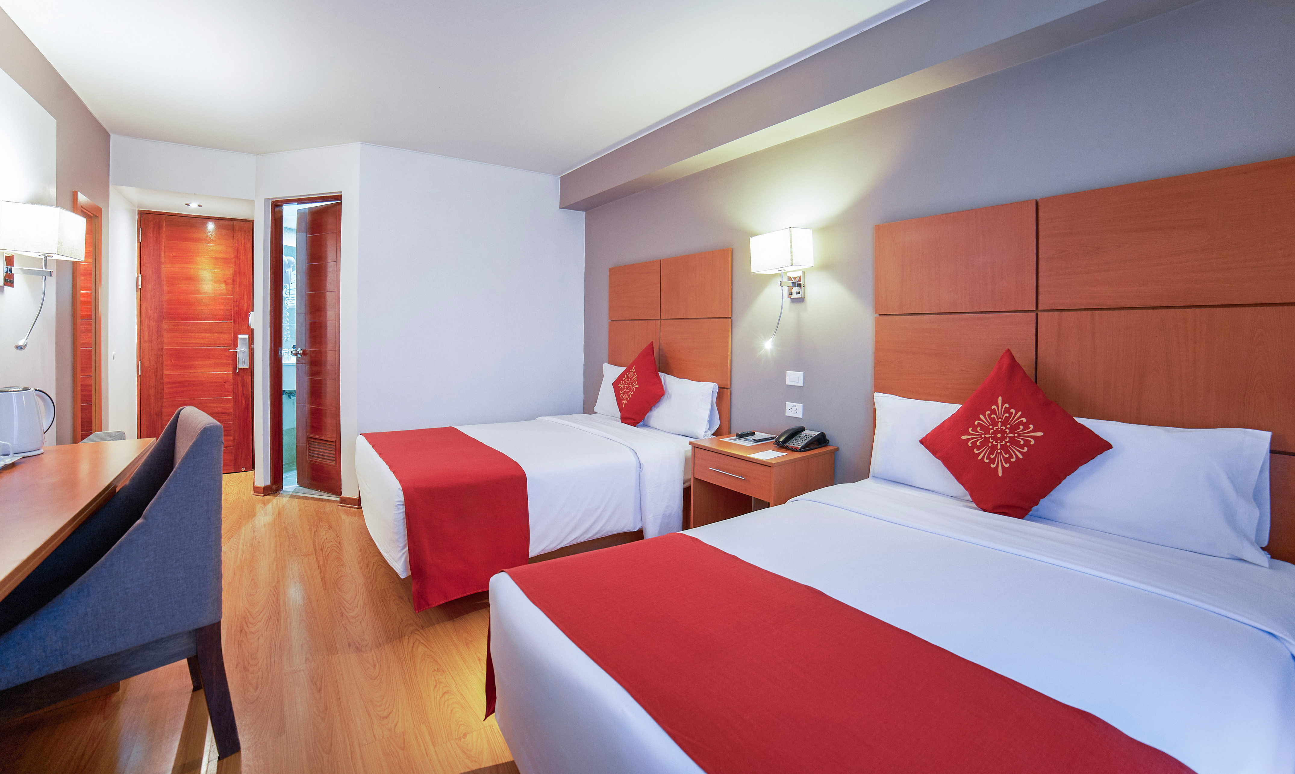 a room with two beds and a door