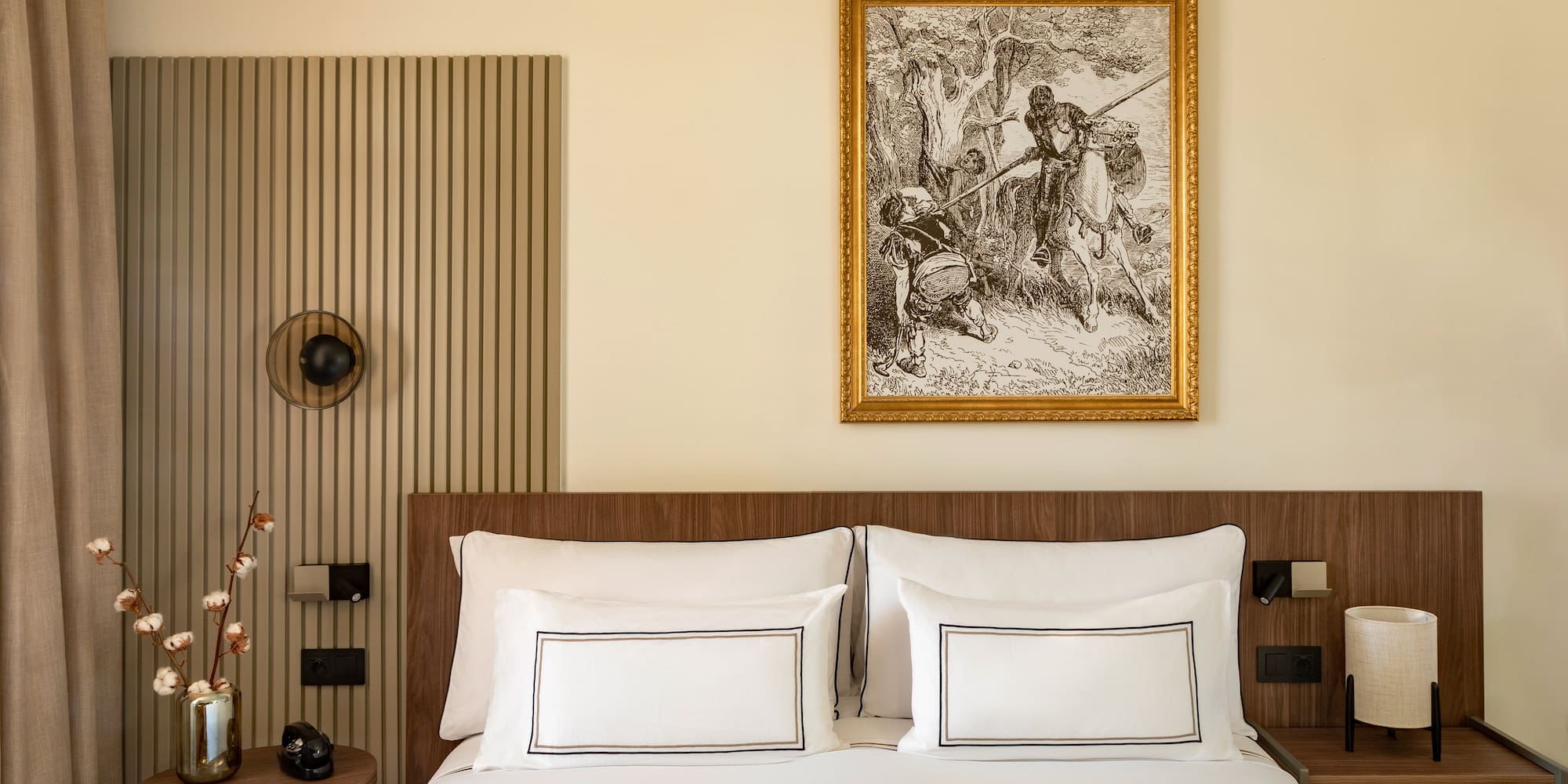 a bed with a picture on the wall