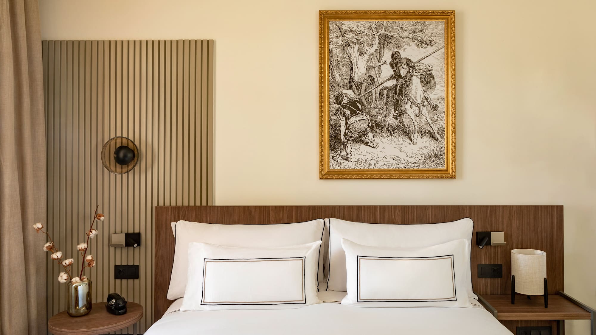 a bed with a picture on the wall