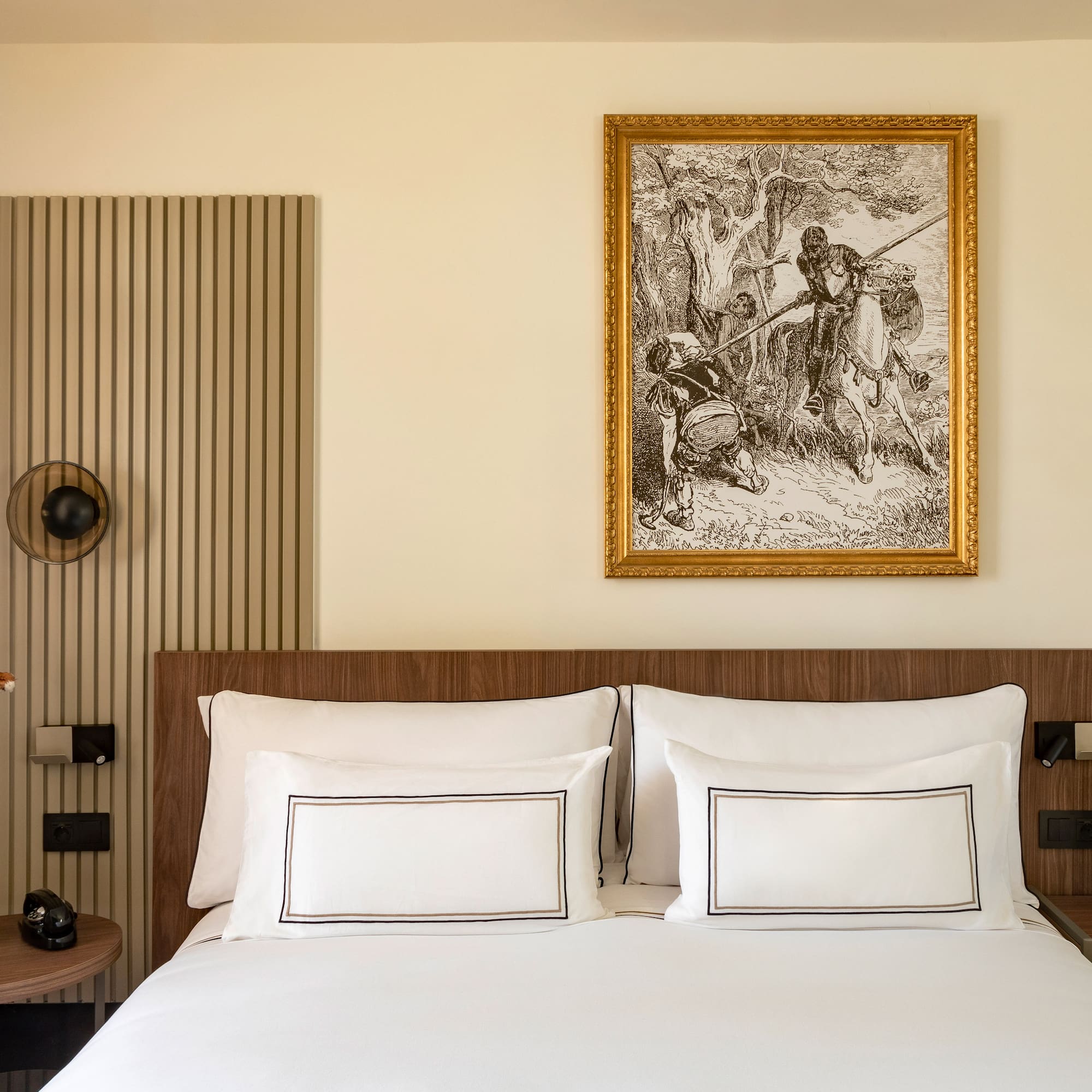 a bed with a picture on the wall