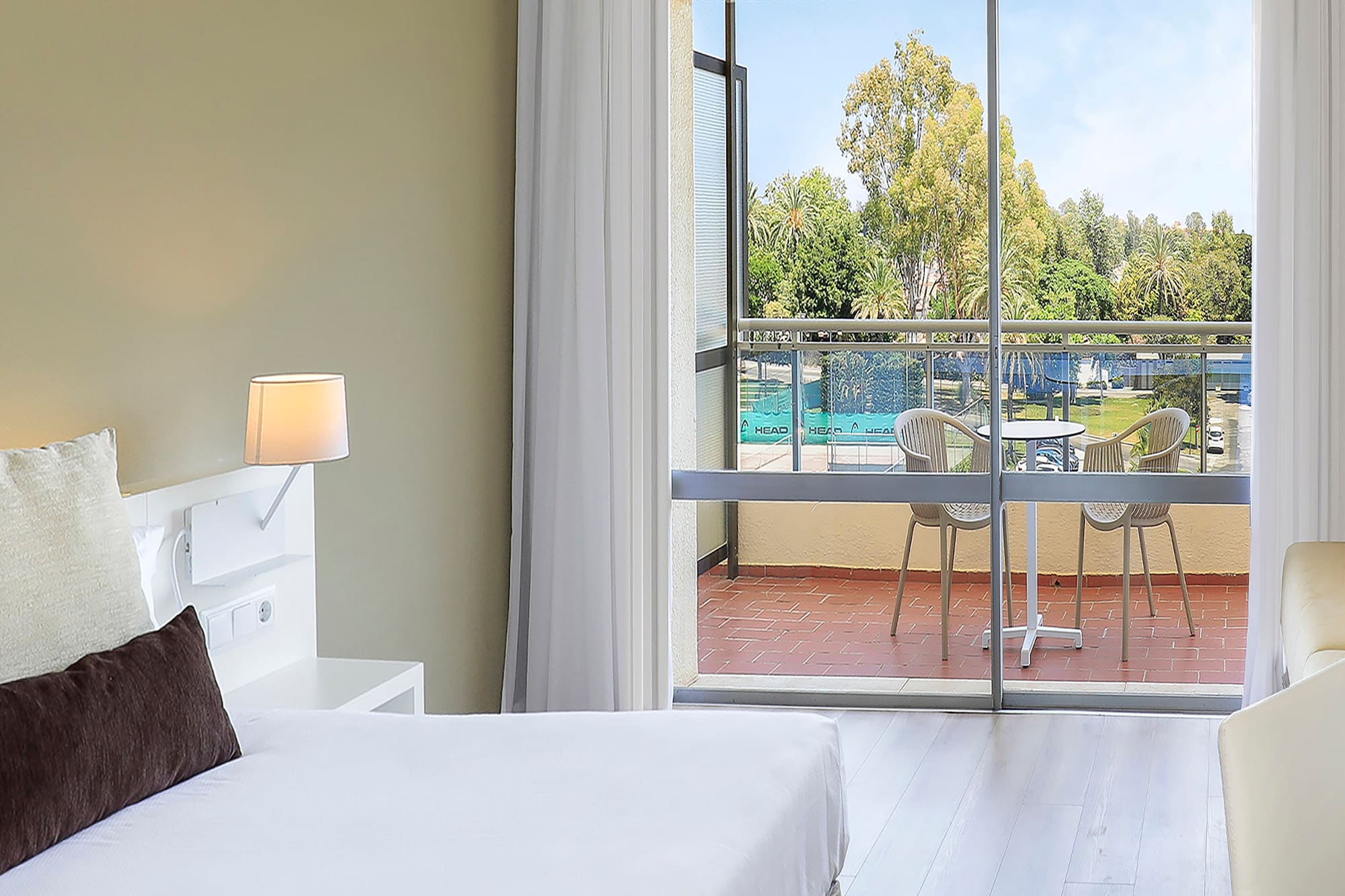 a bedroom with two beds and a glass door