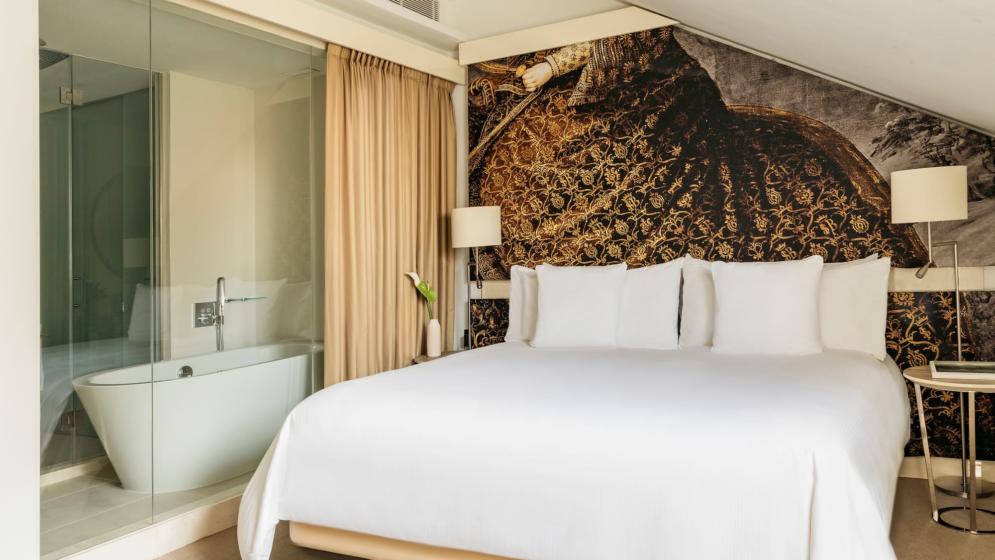 a bed with white sheets and a bathtub in a room