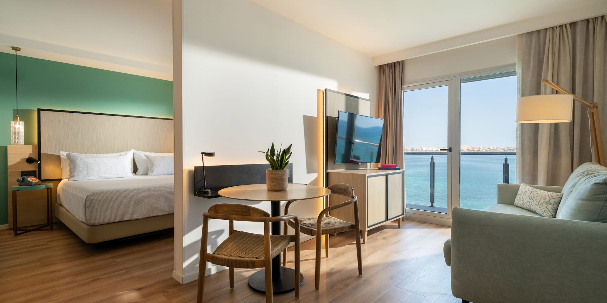 a room with a table and chairs and a television