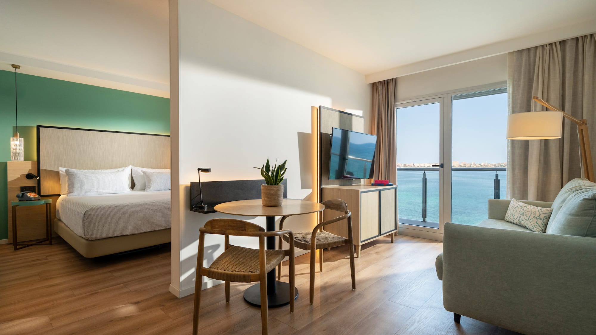 a room with a table and chairs and a television