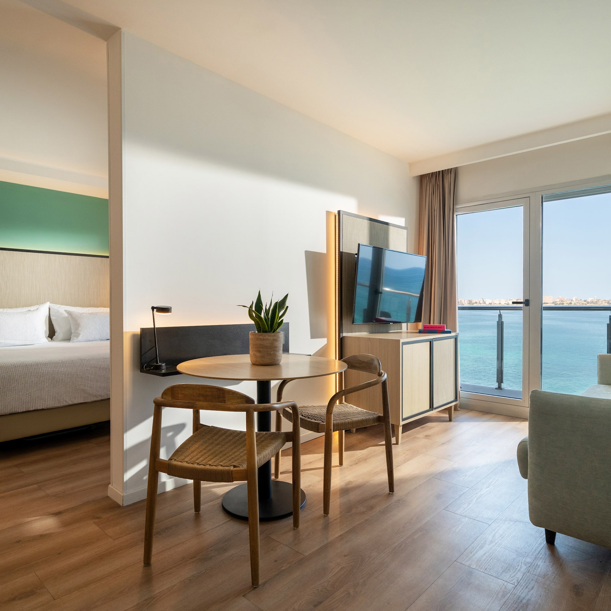 a room with a table and chairs and a television