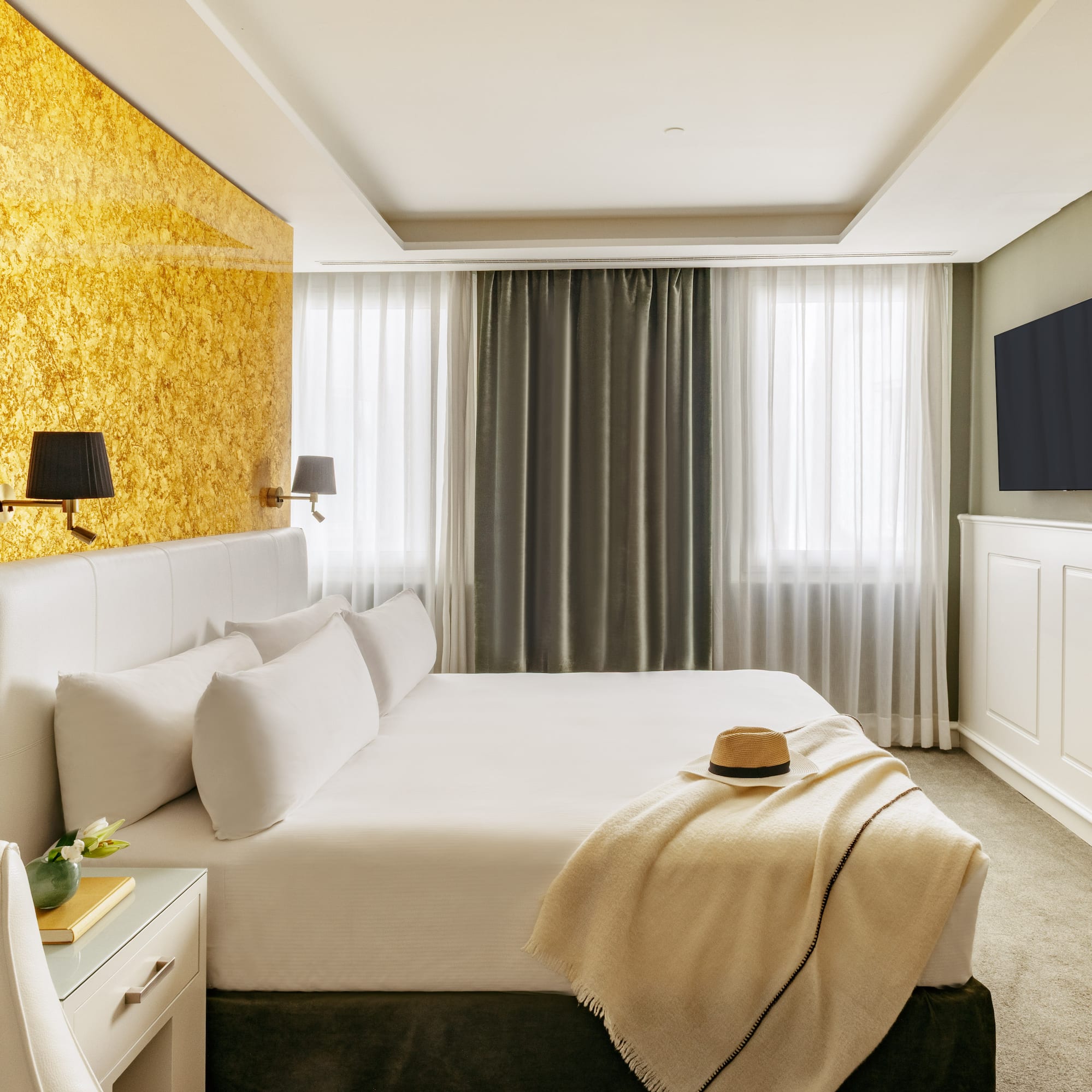 a bed with a hat on it