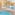Indoor hotel spa with swimming pool, two hot tubs, and lounge chairs.