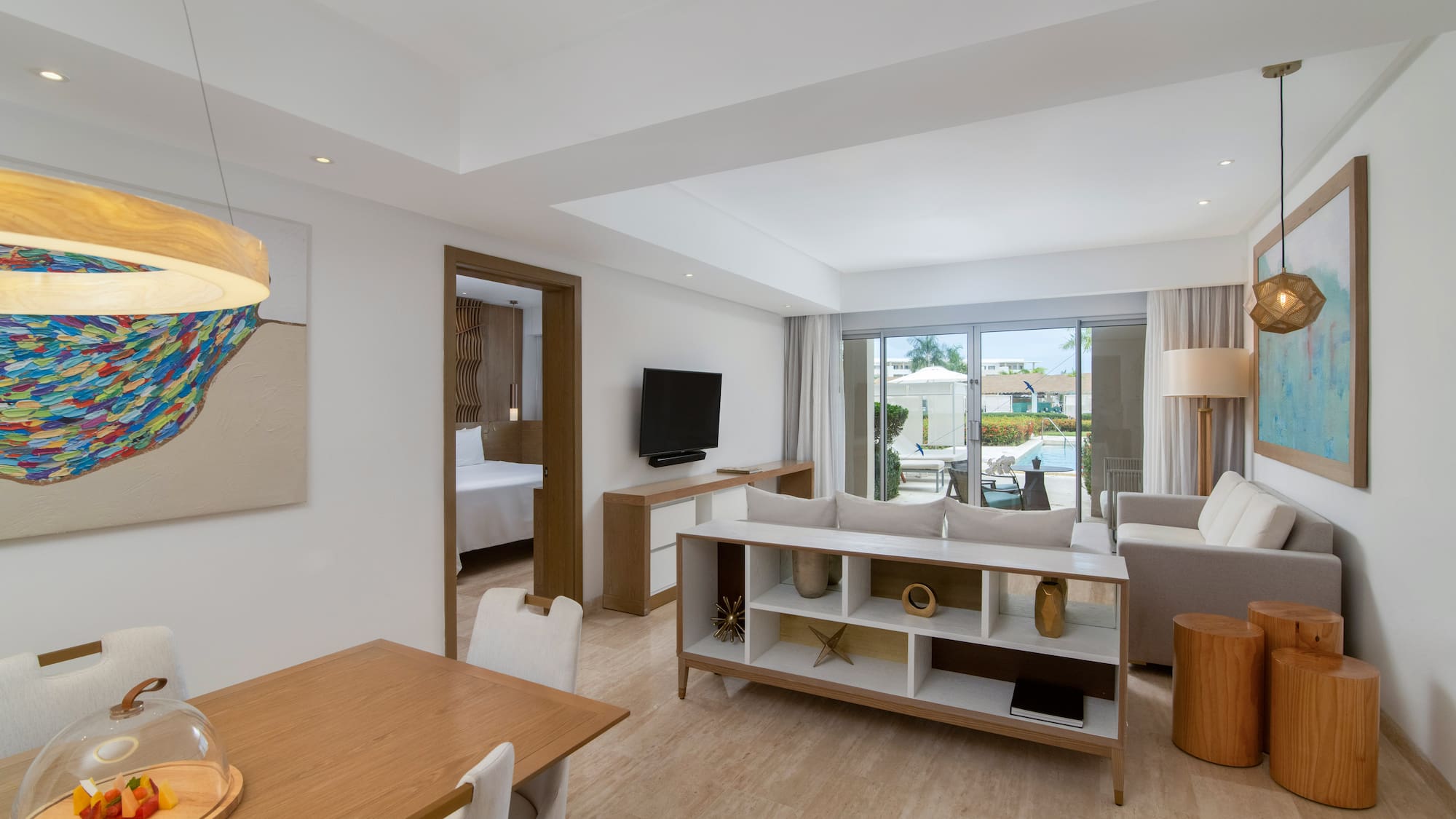 a room with a table and chairs and a tv