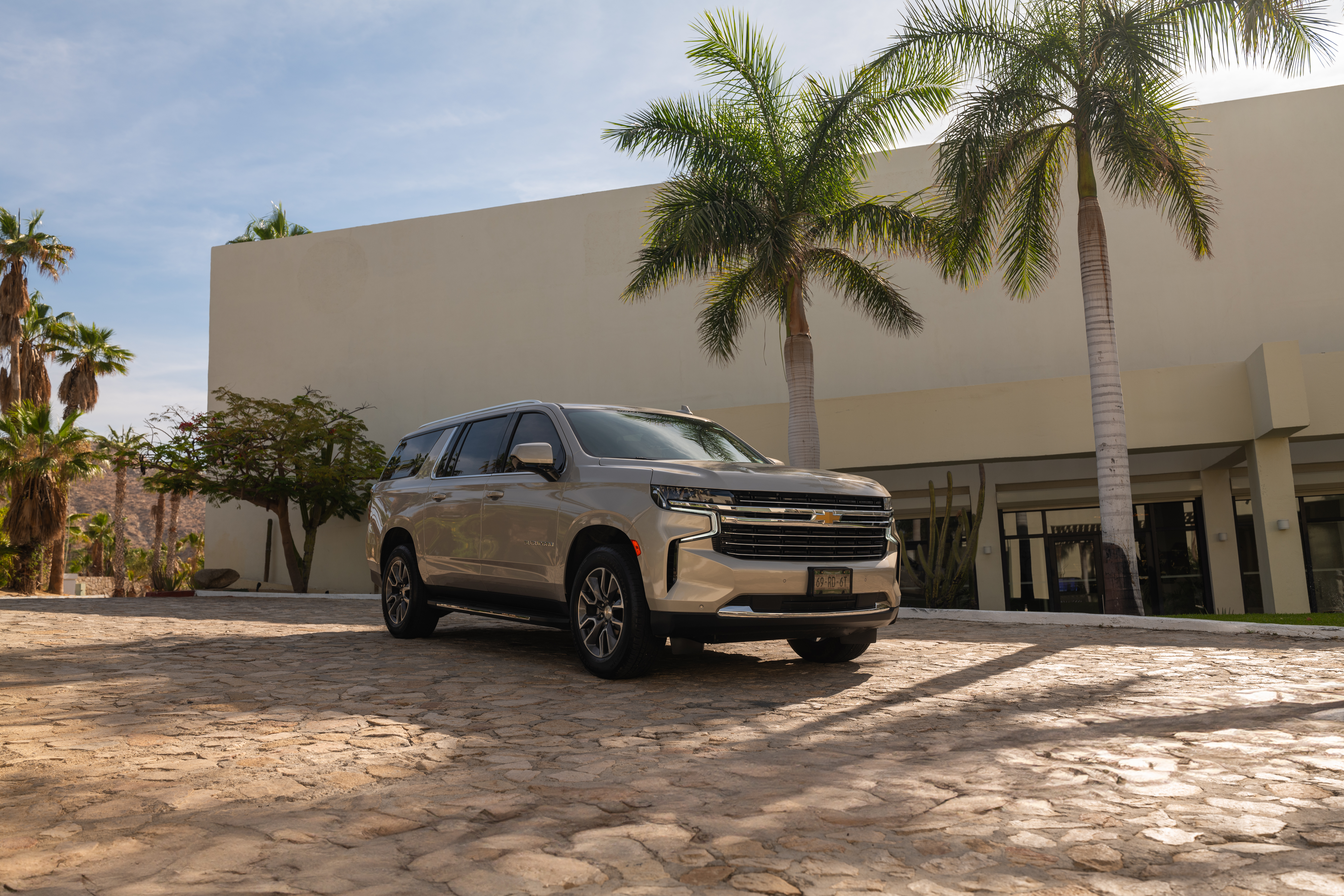 a silver car parked in front of a building