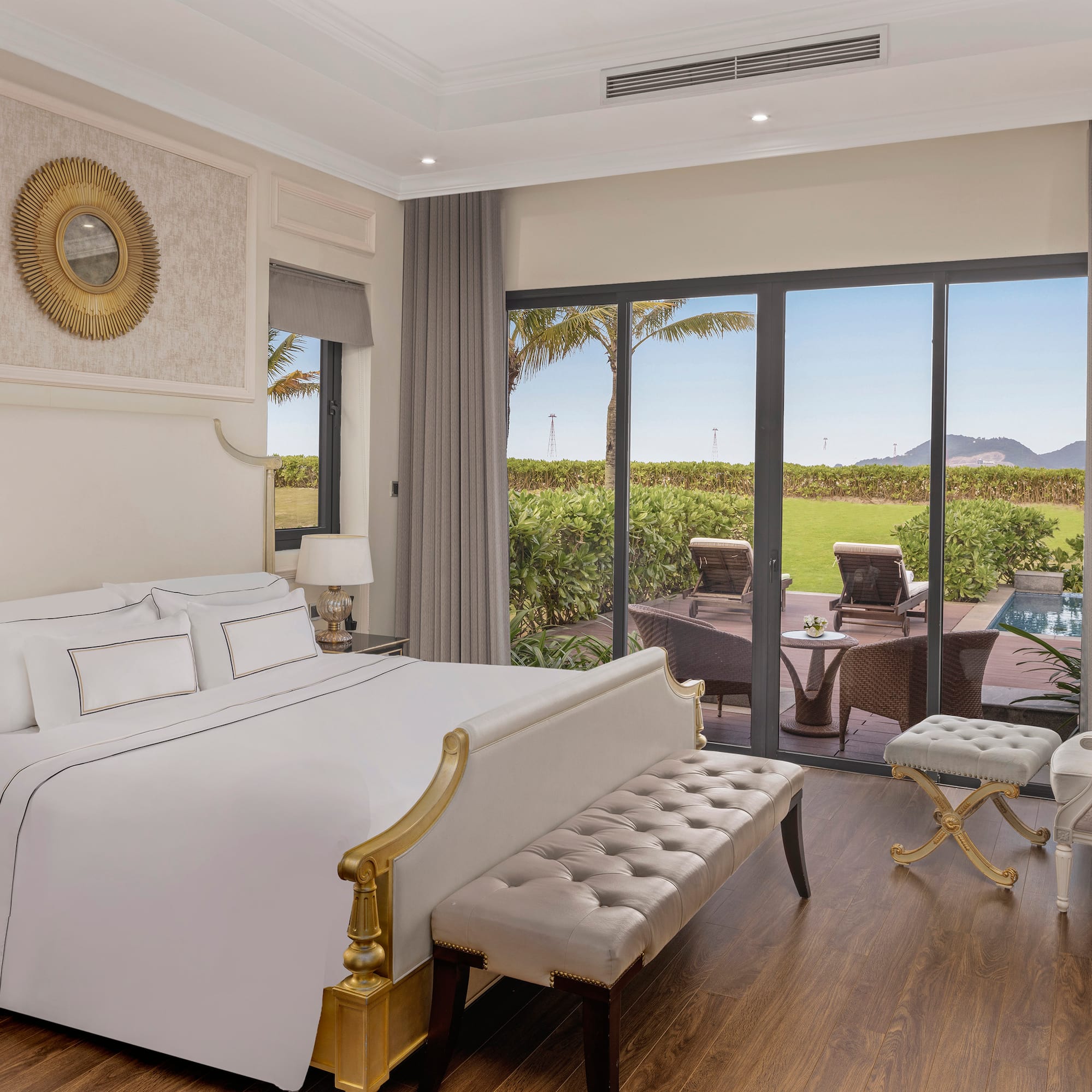 a bedroom with a large bed and a pool in the background