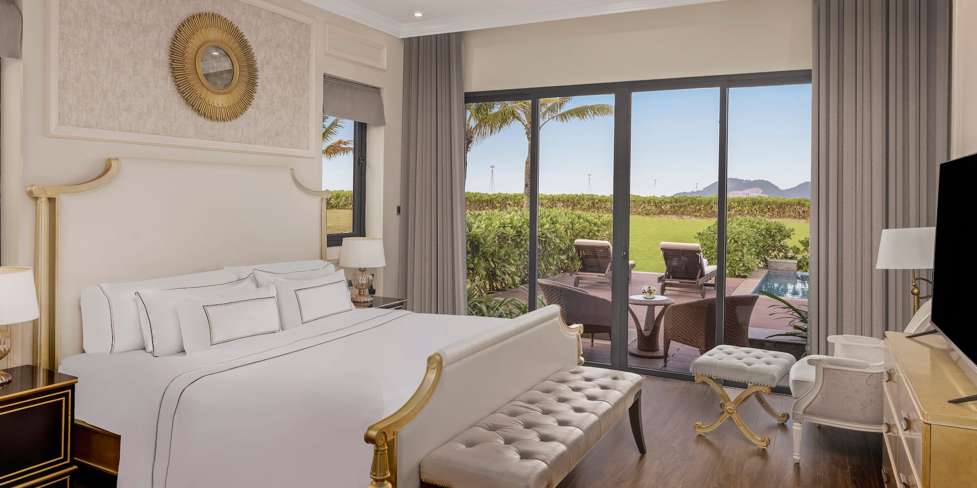 a bedroom with a large bed and a pool in the background