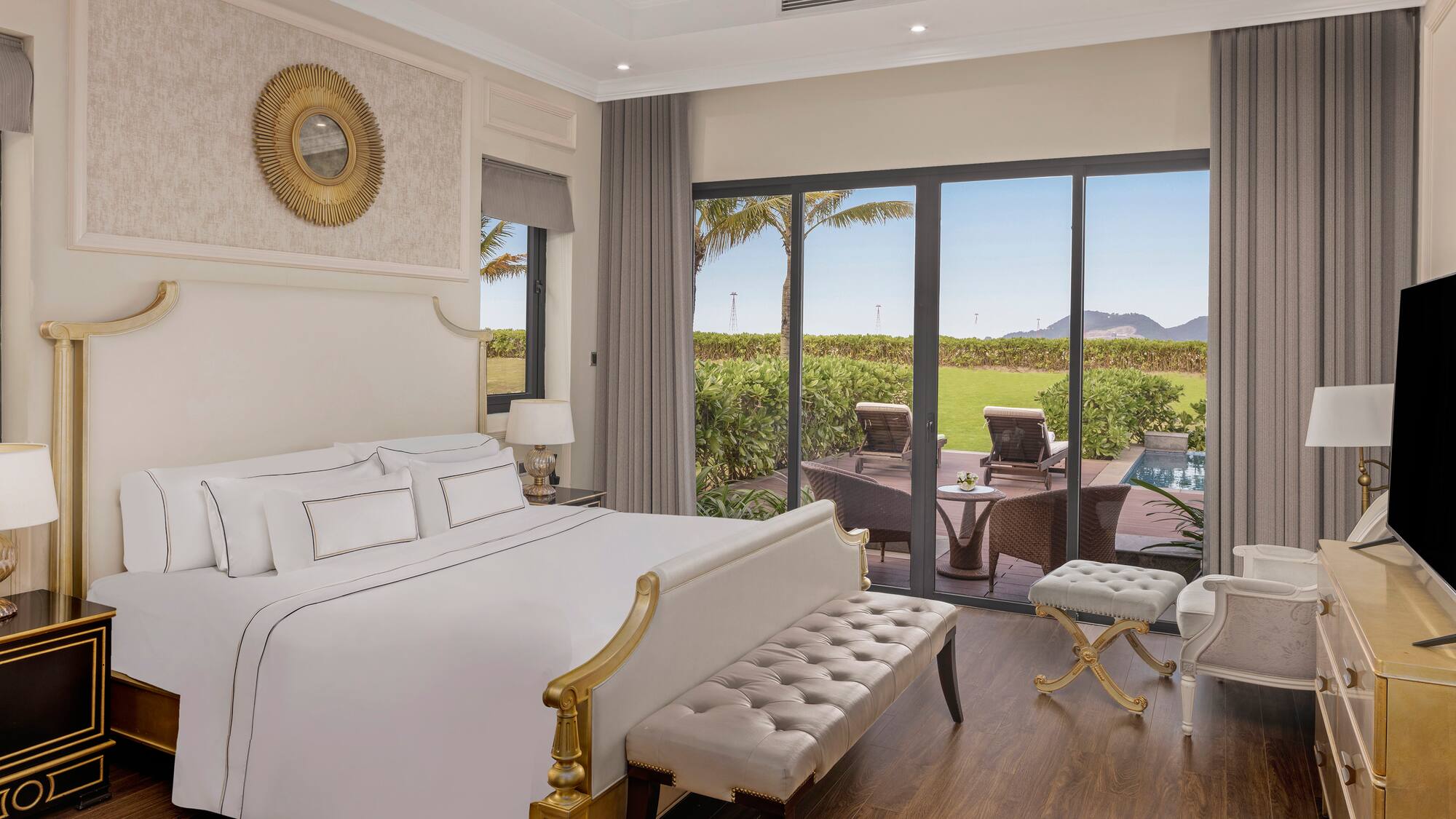 a bedroom with a large bed and a pool in the background