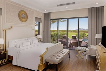 a bedroom with a large bed and a pool in the background