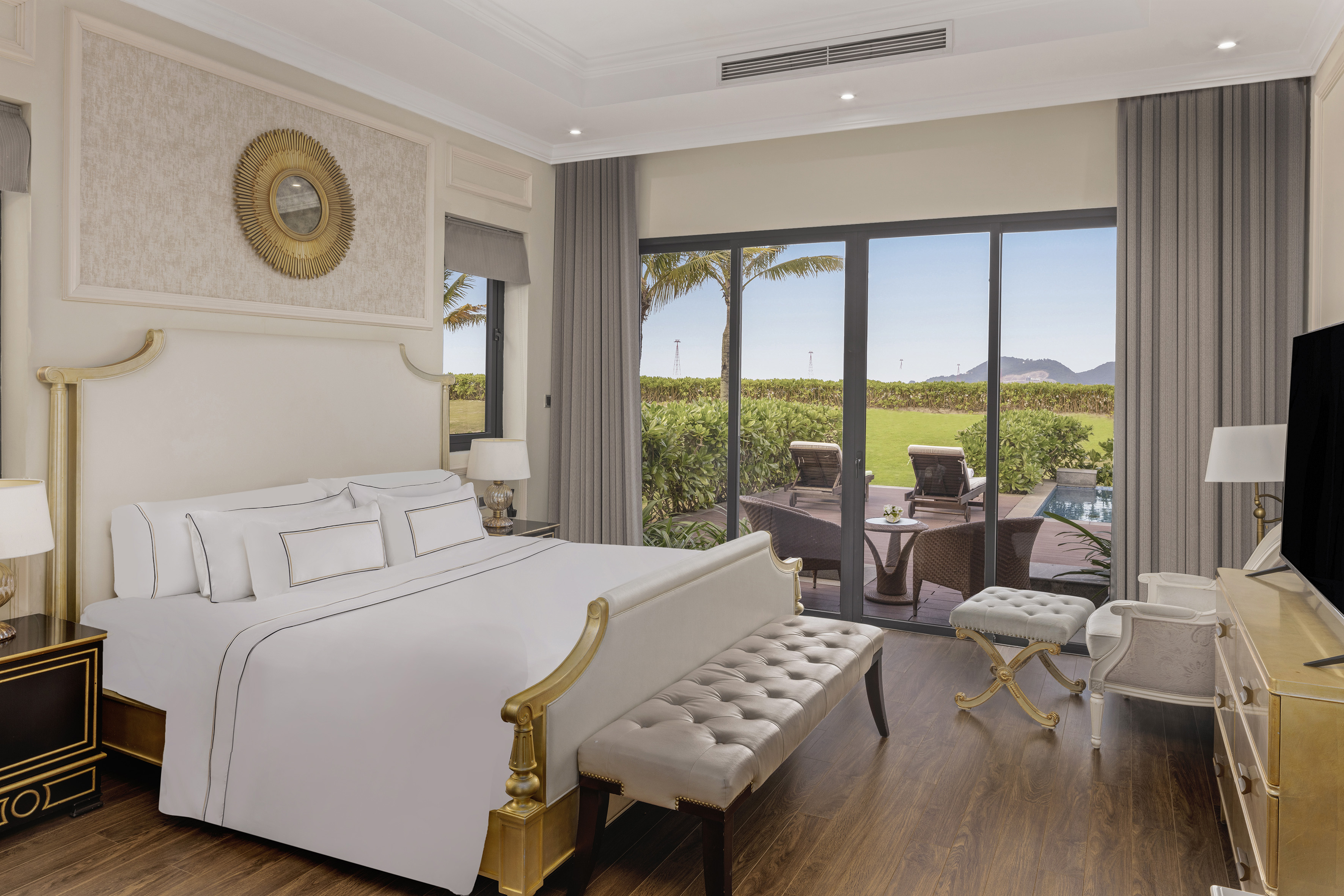 a bedroom with a large bed and a pool in the background