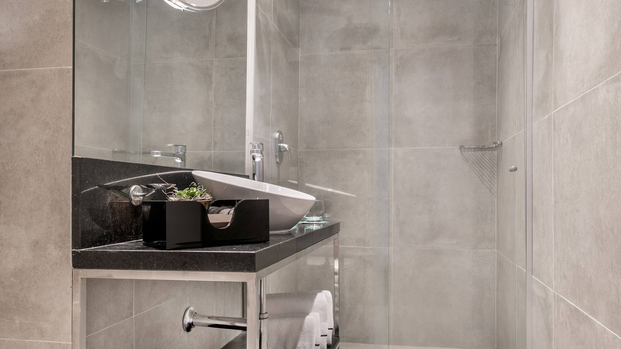 a bathroom with a glass shower door