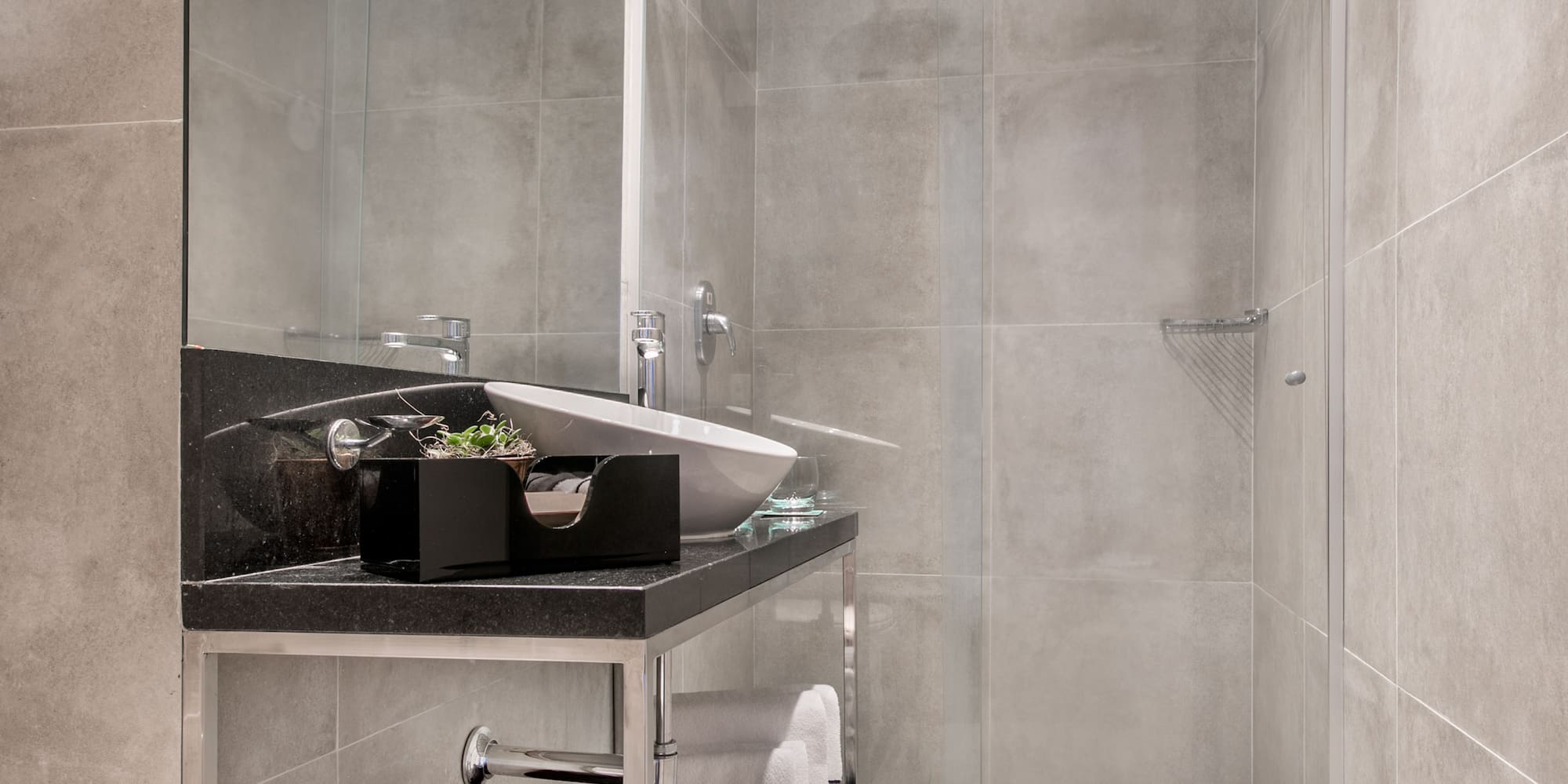 a bathroom with a glass shower door