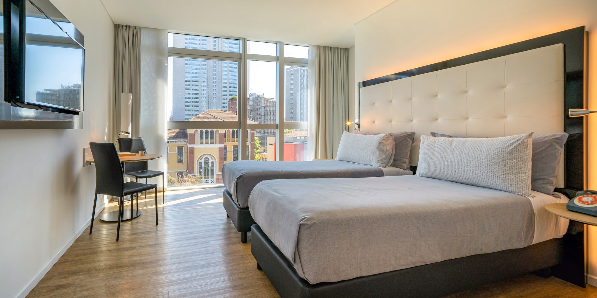 a room with two beds and a desk