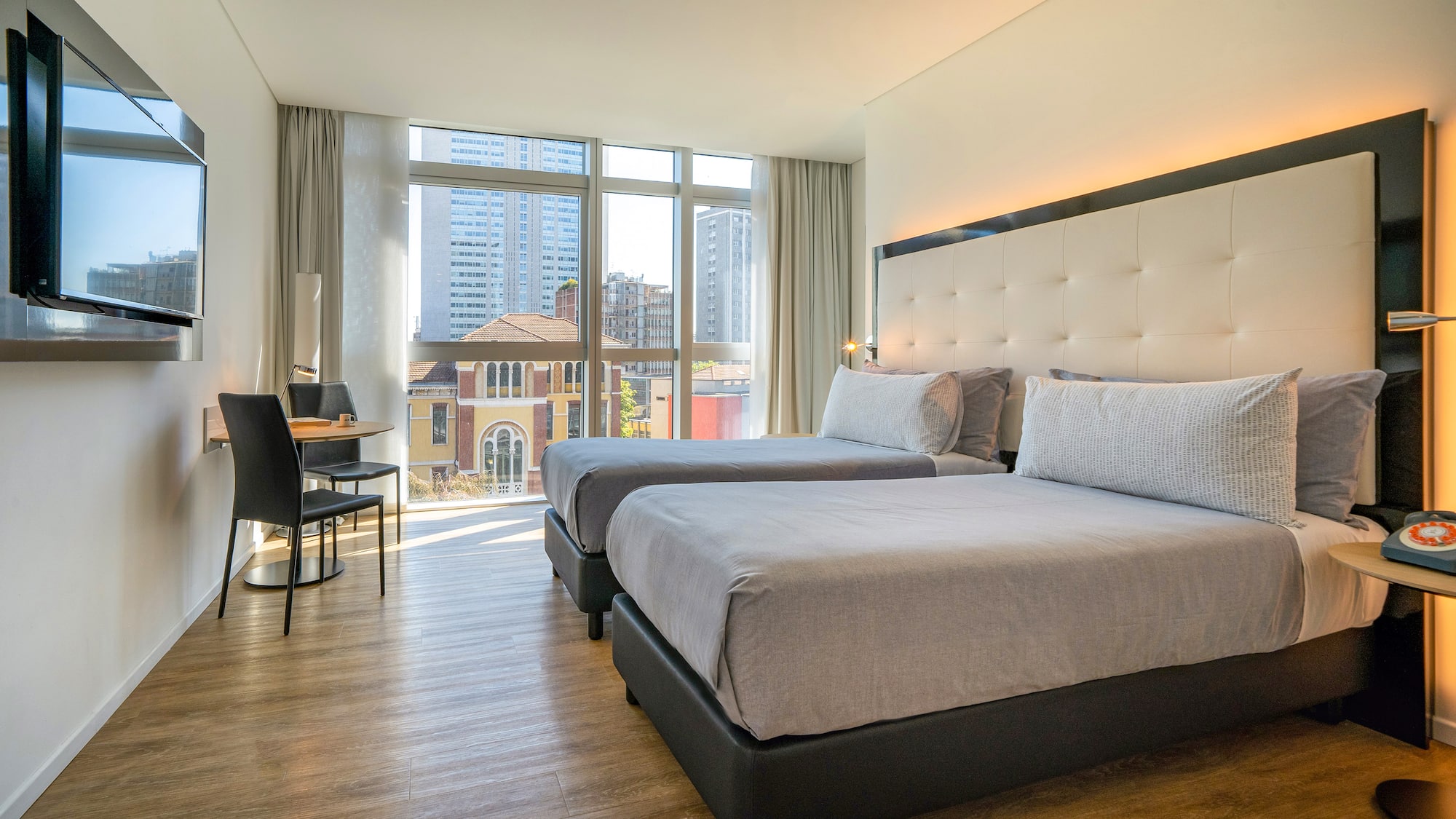 a room with two beds and a desk