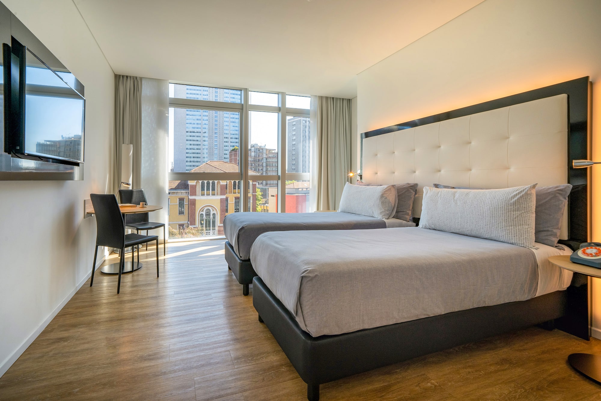 a room with two beds and a desk