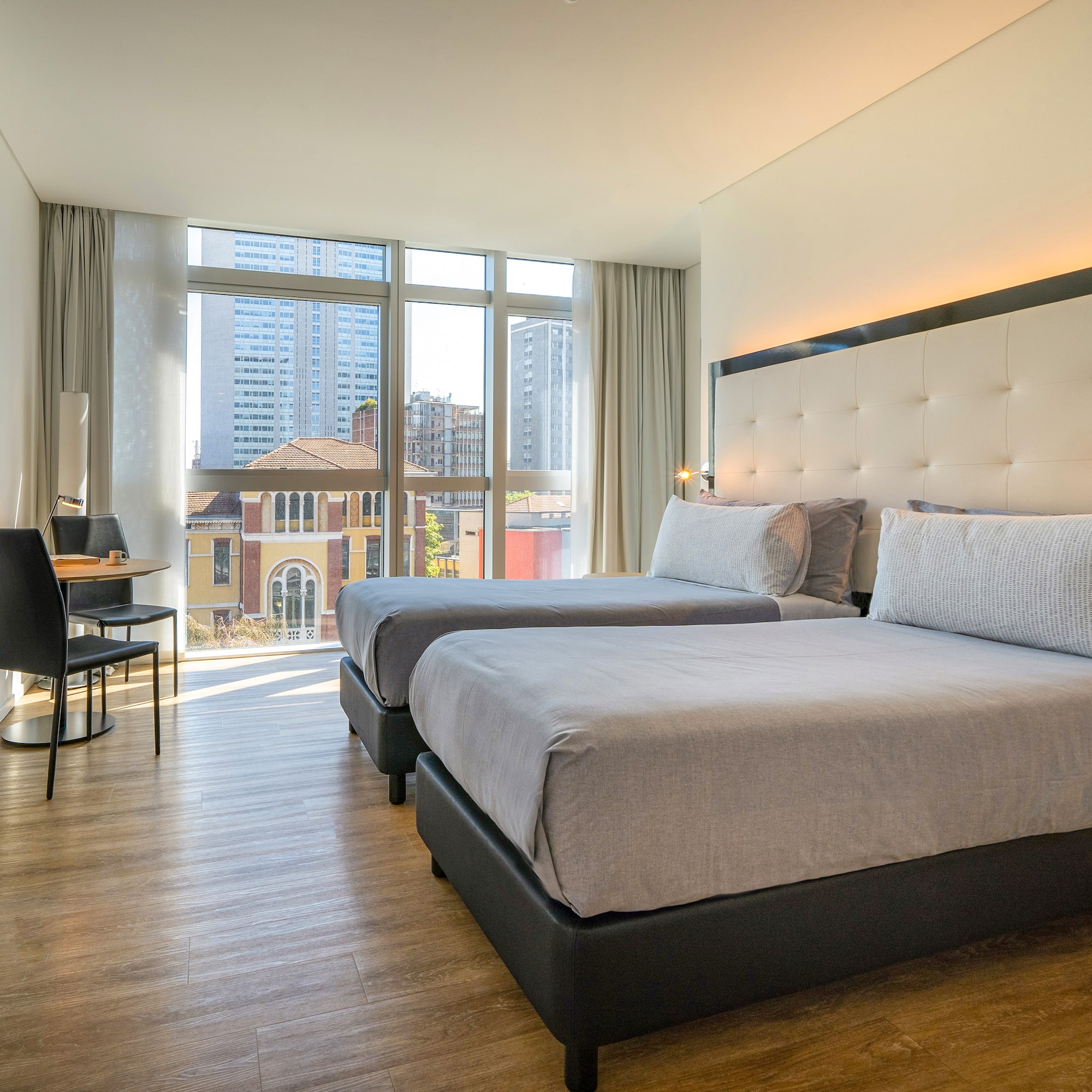 a room with two beds and a desk