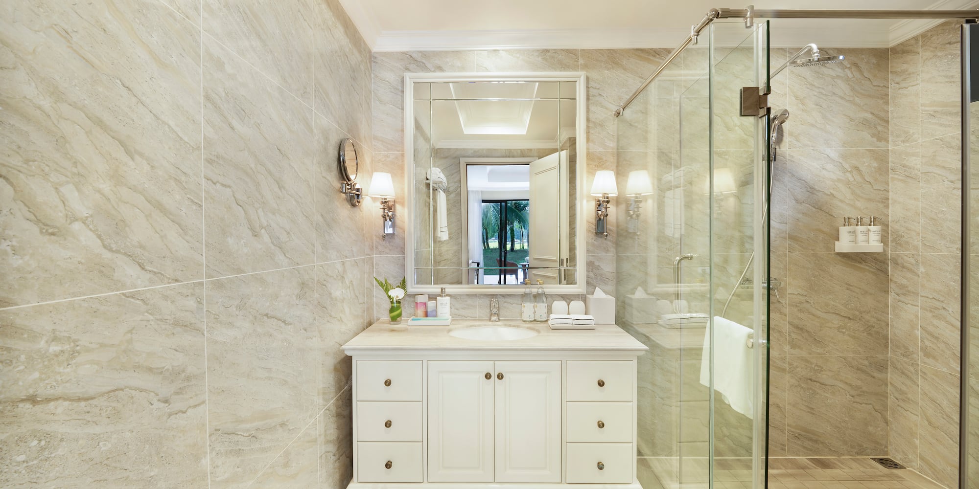 a bathroom with a glass shower and a sink
