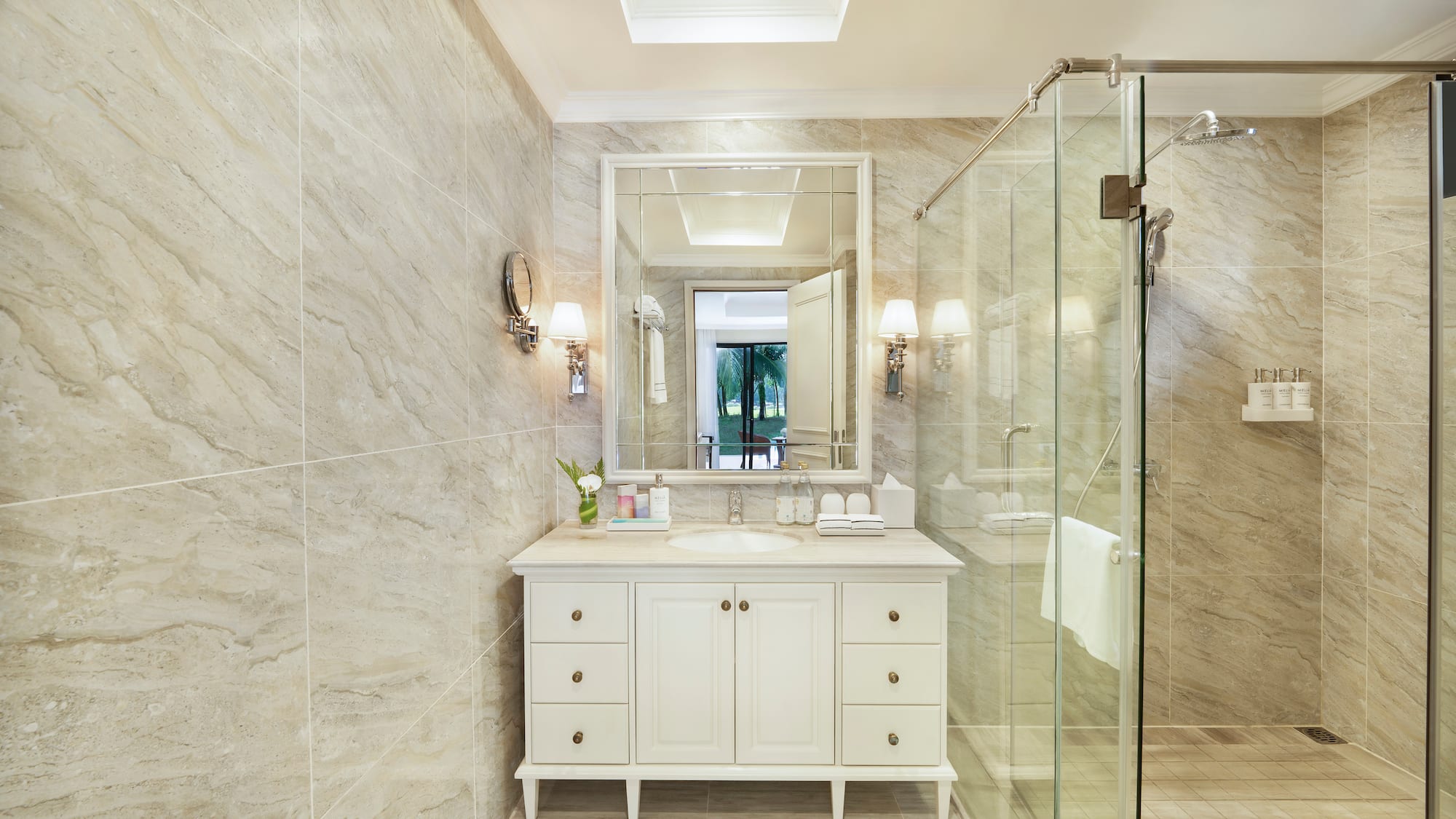 a bathroom with a glass shower and a sink