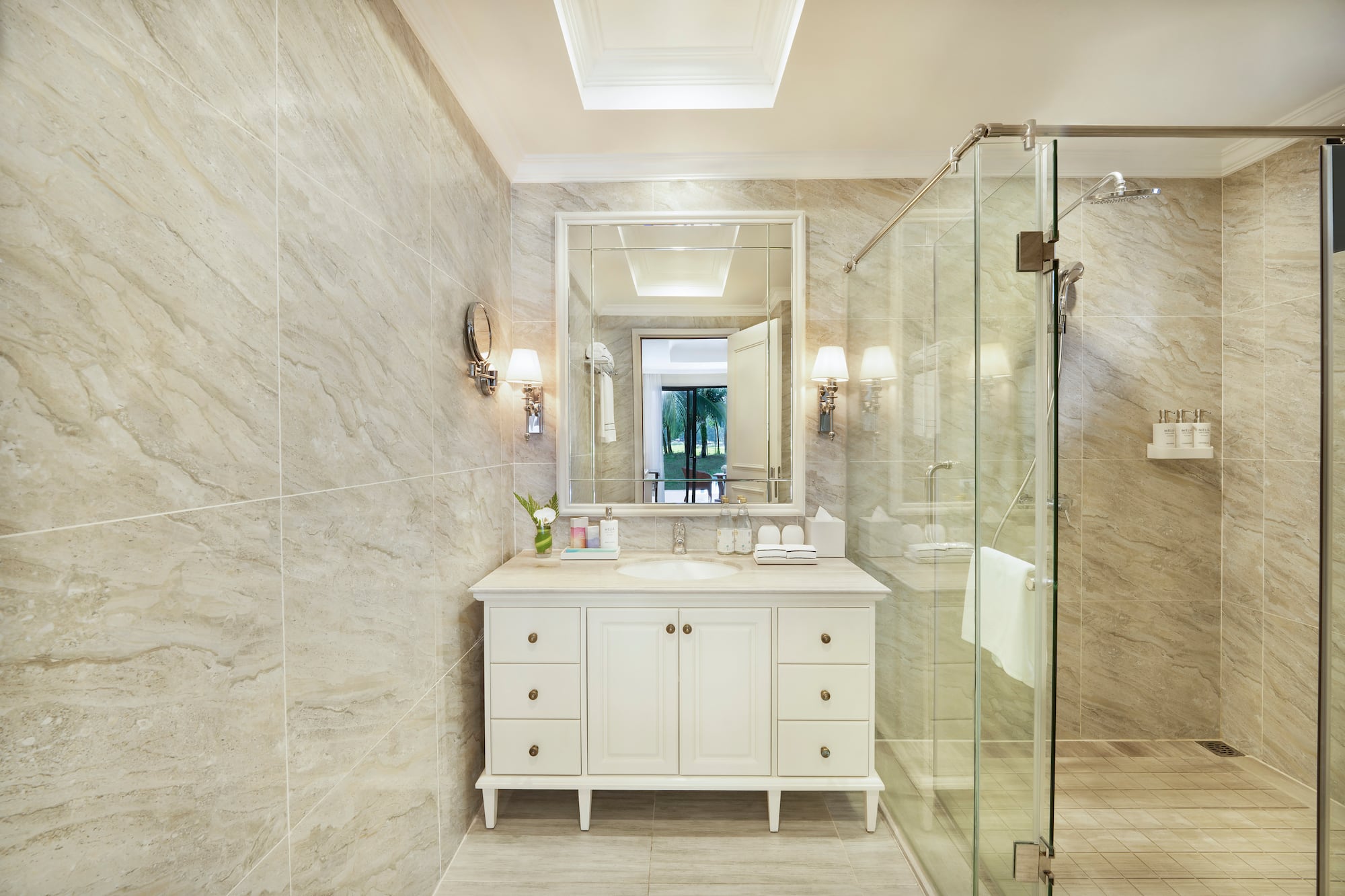a bathroom with a glass shower and a sink