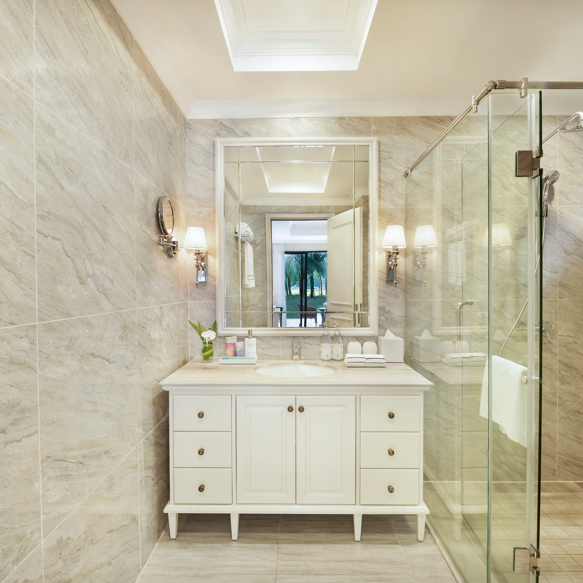 a bathroom with a glass shower and a sink