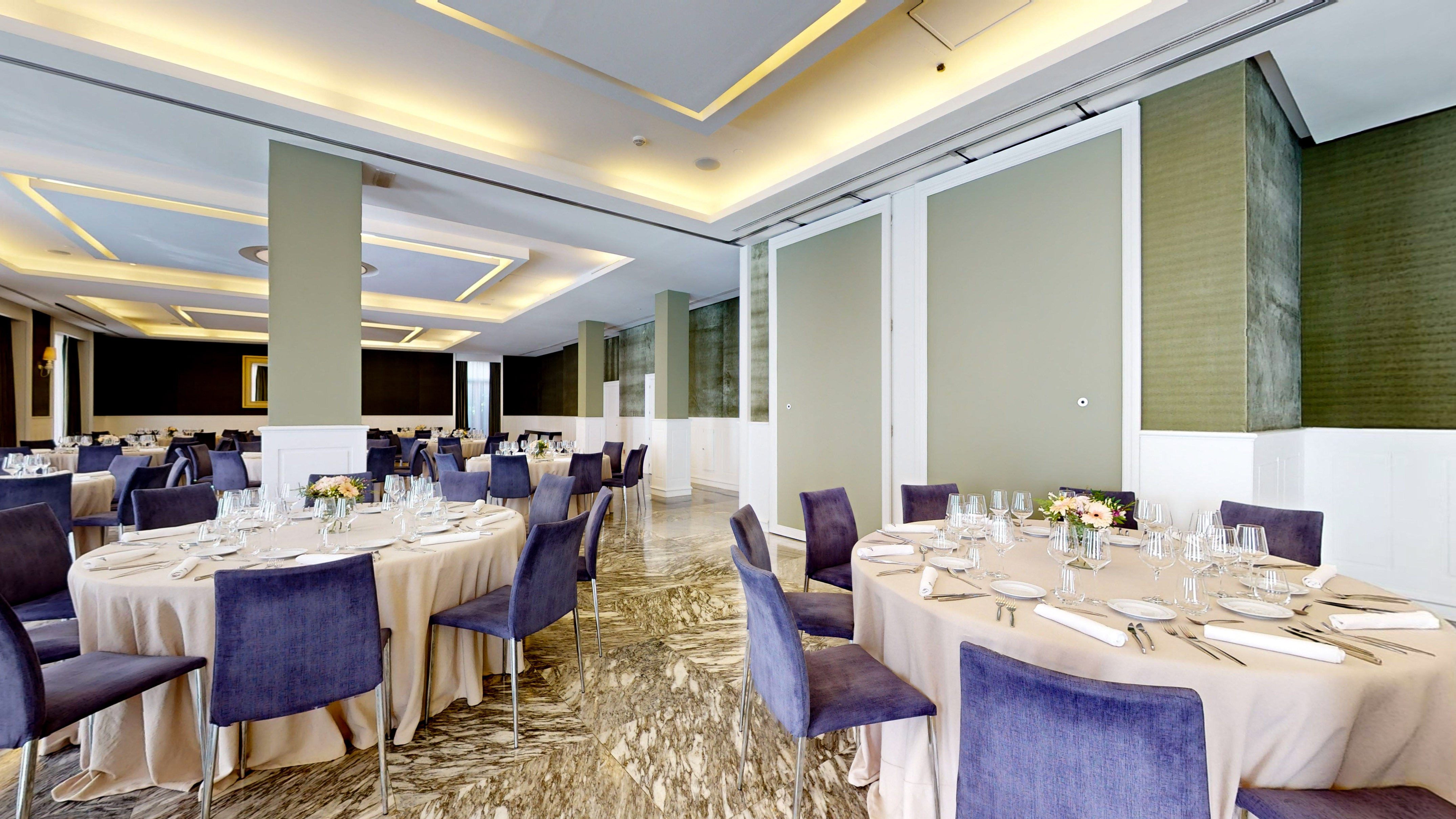 Elegant banquet hall with round tables, purple chairs, and polished marble floor.