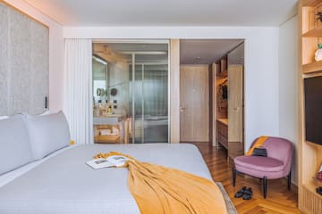 a bed with a chair in a room