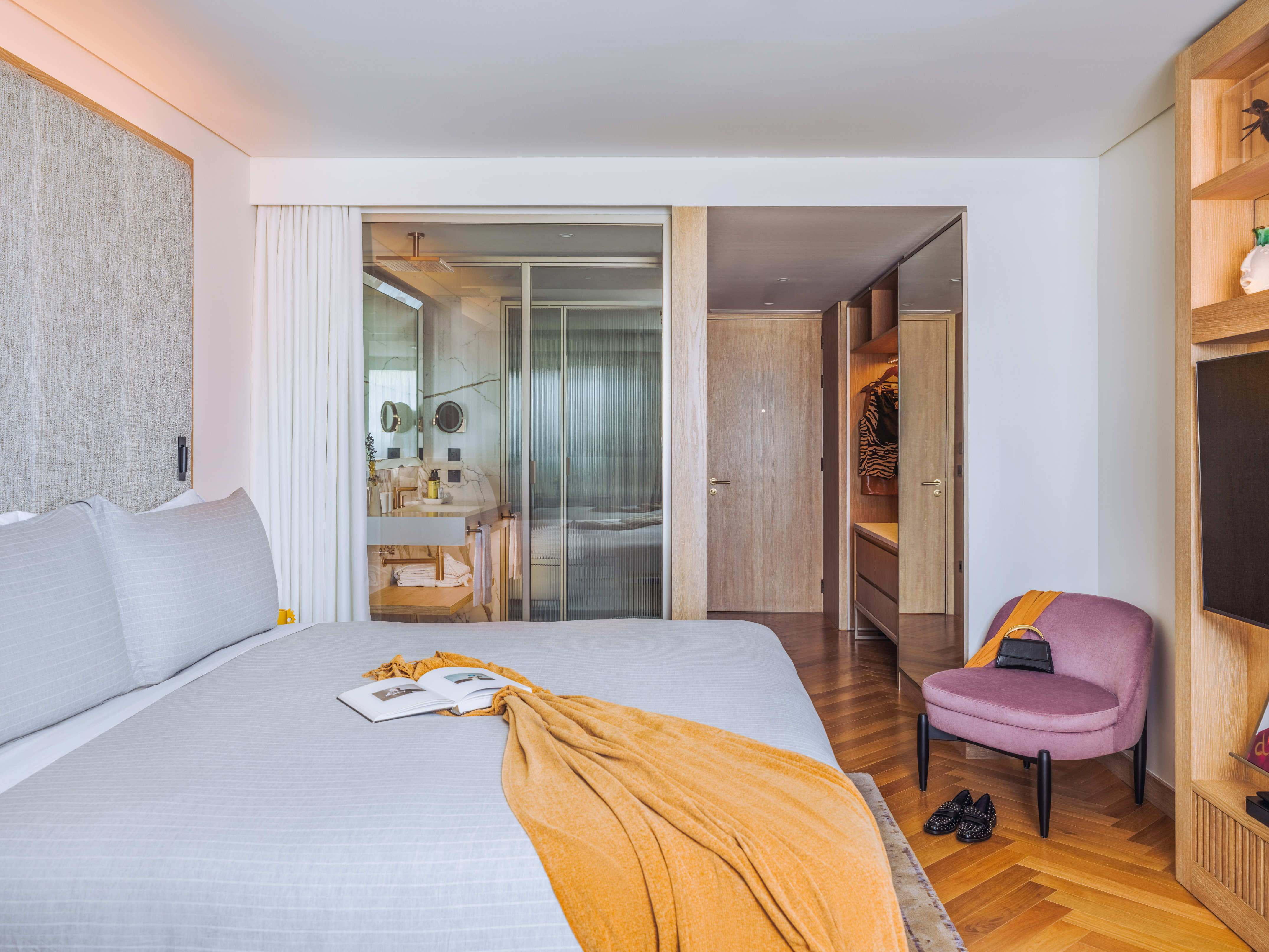 a bed with a chair in a room