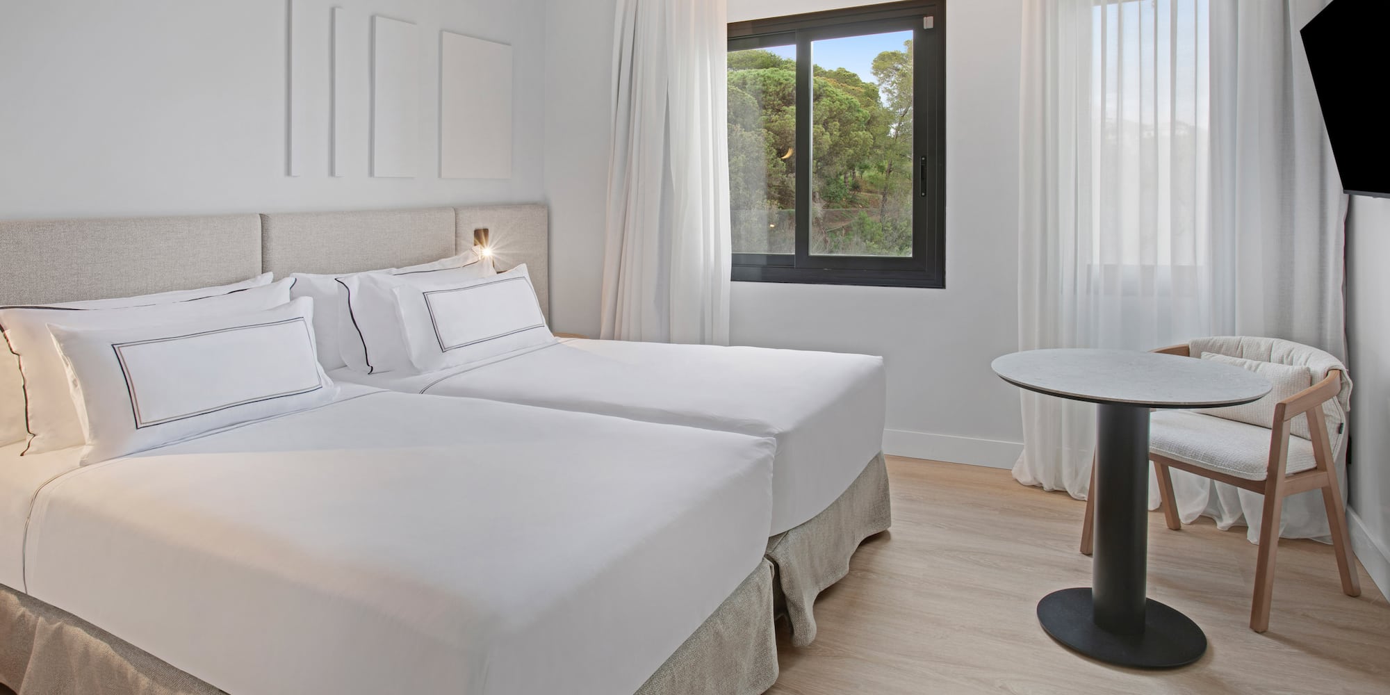 a room with two beds and a table