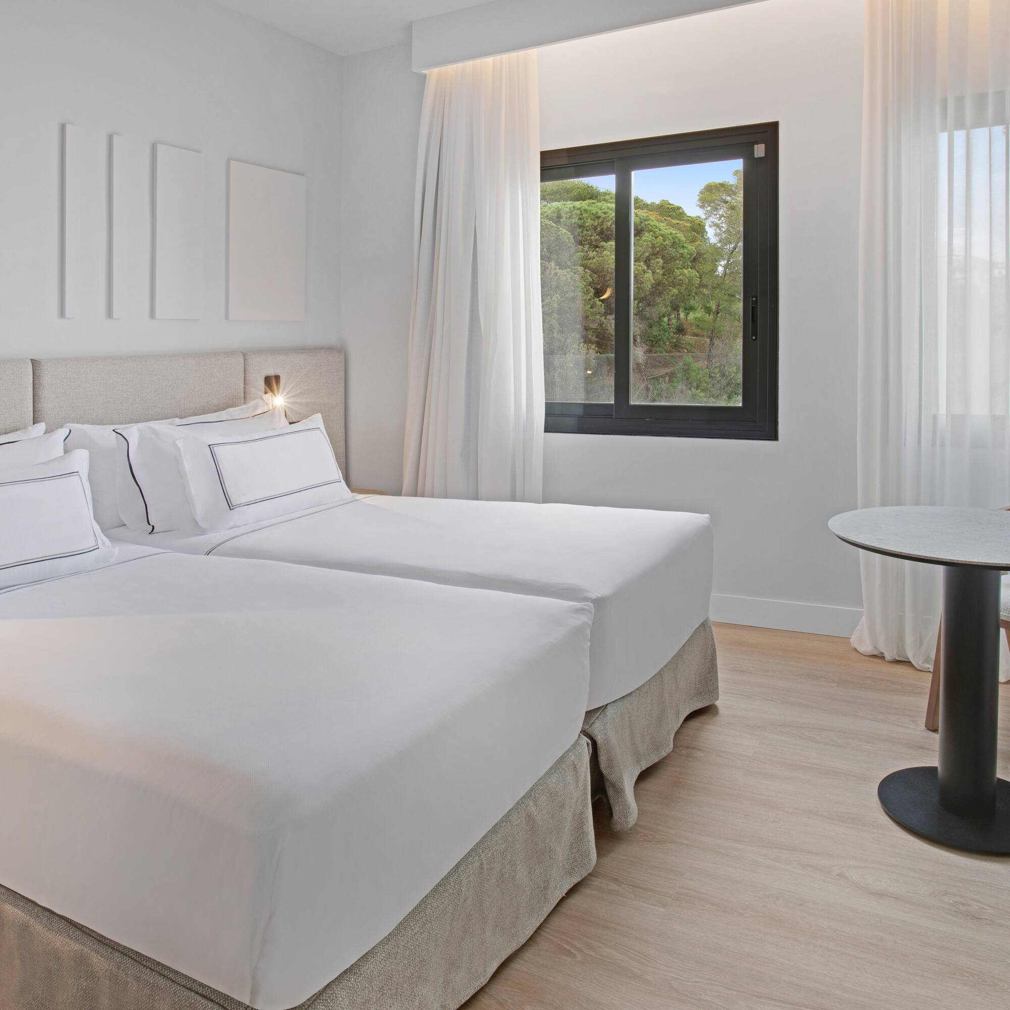 a room with two beds and a table