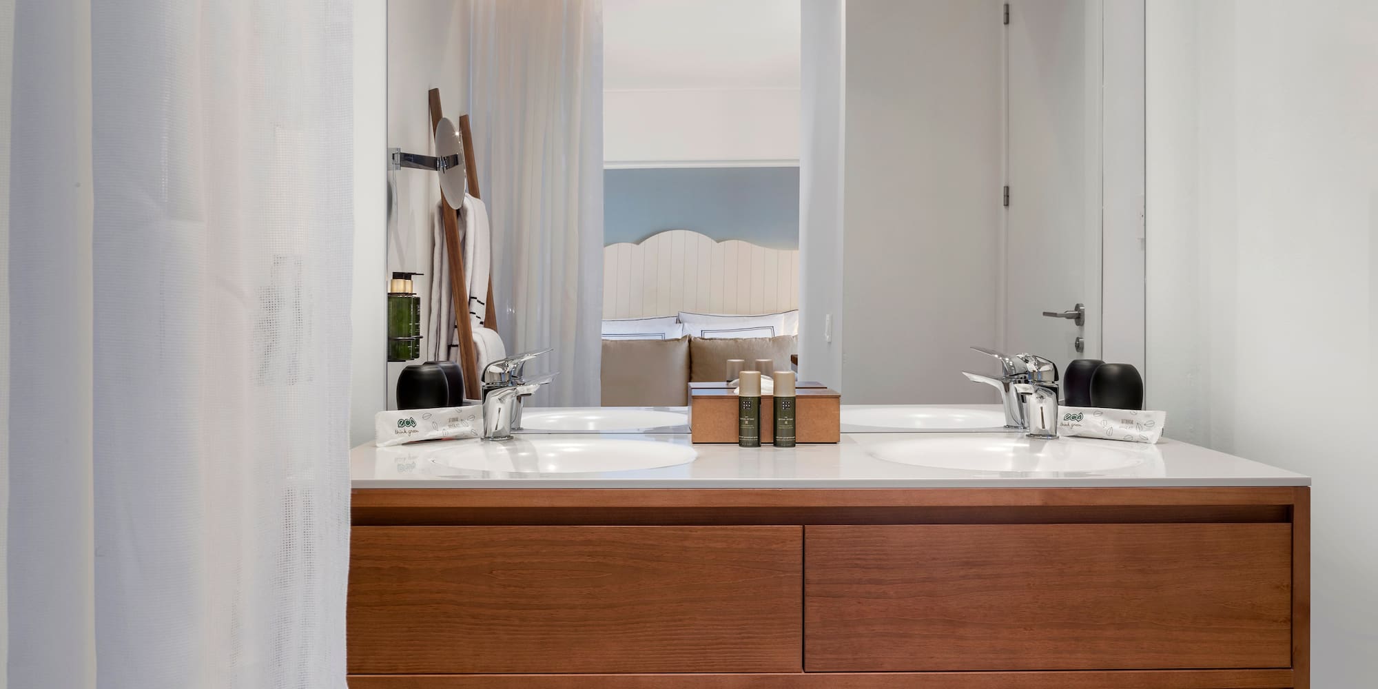 a bathroom with a double sink and mirror