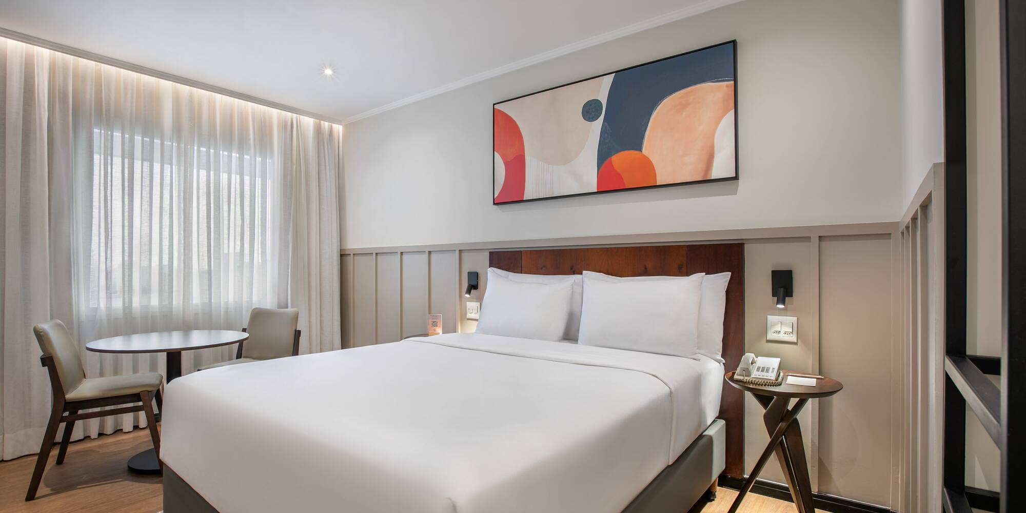 a bed with a table and chairs in a room