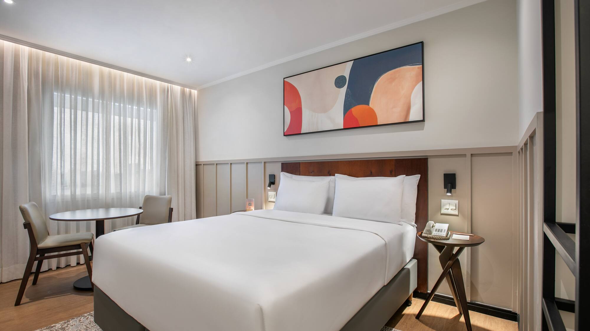 a bed with a table and chairs in a room