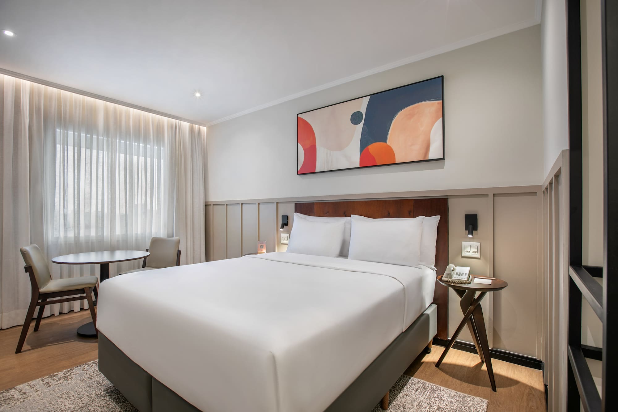 a bed with a table and chairs in a room