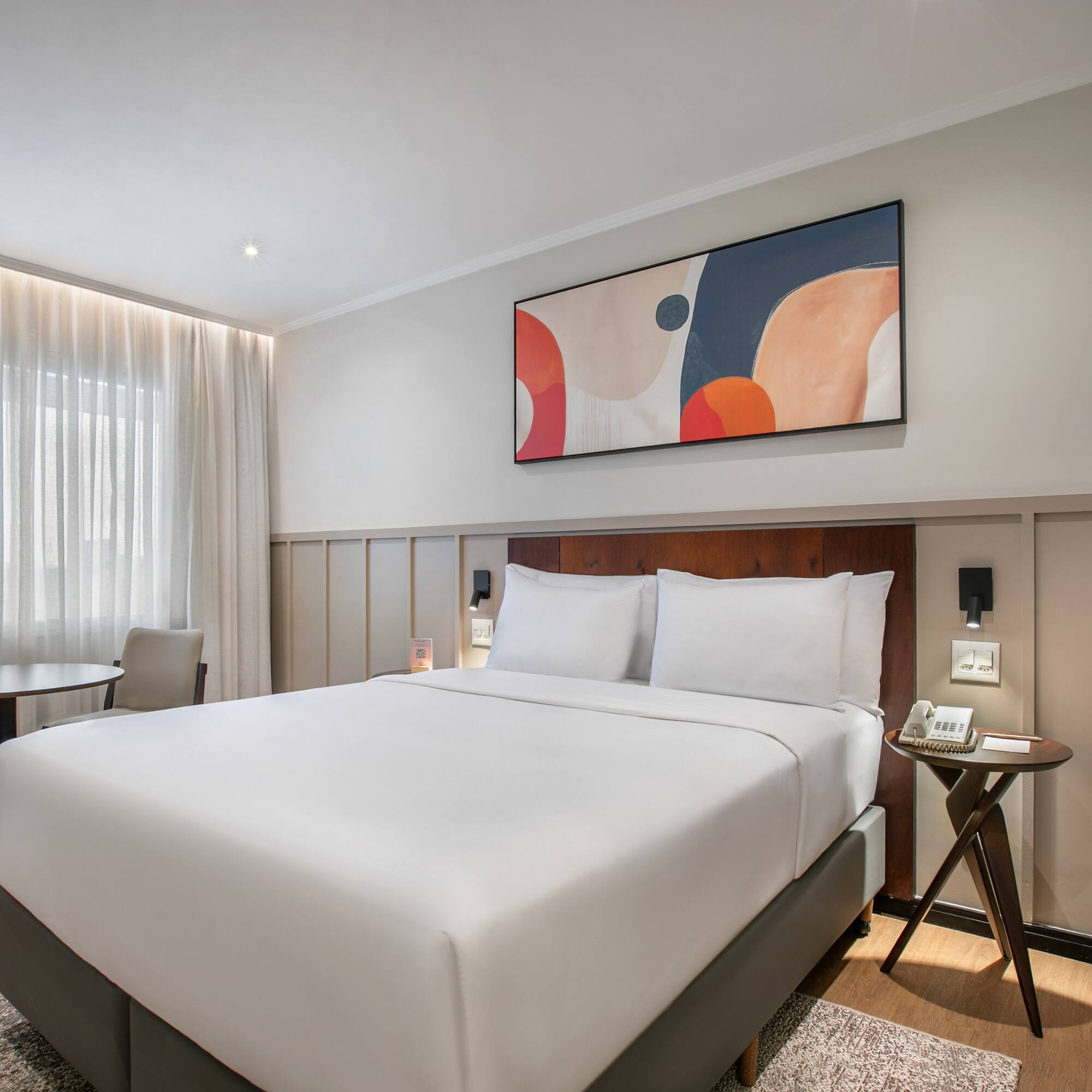 a bed with a table and chairs in a room