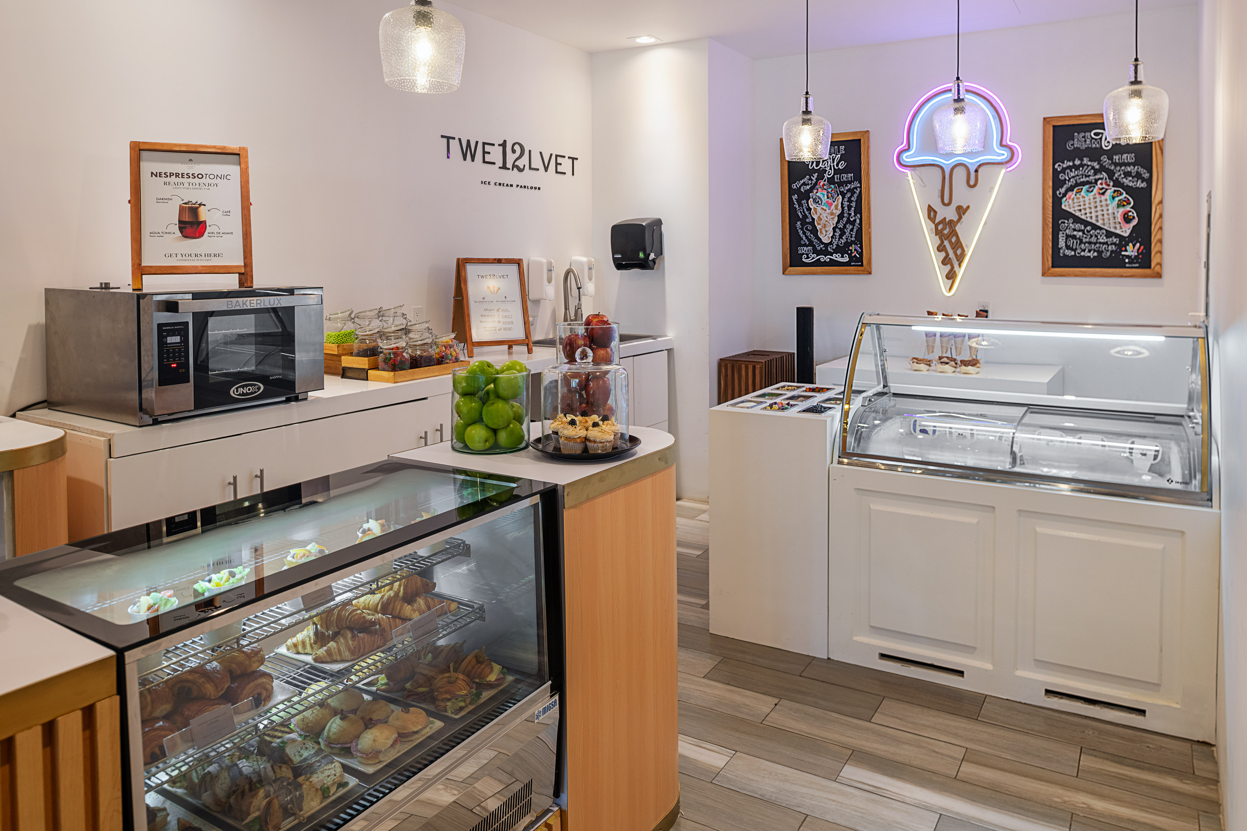 TWE12LVET Ice Cream Parlour: pastries, Nespresso, and neon ice cream cone sign.