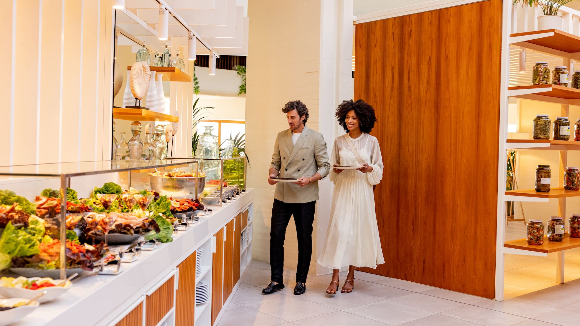a man and woman standing in front of a buffet