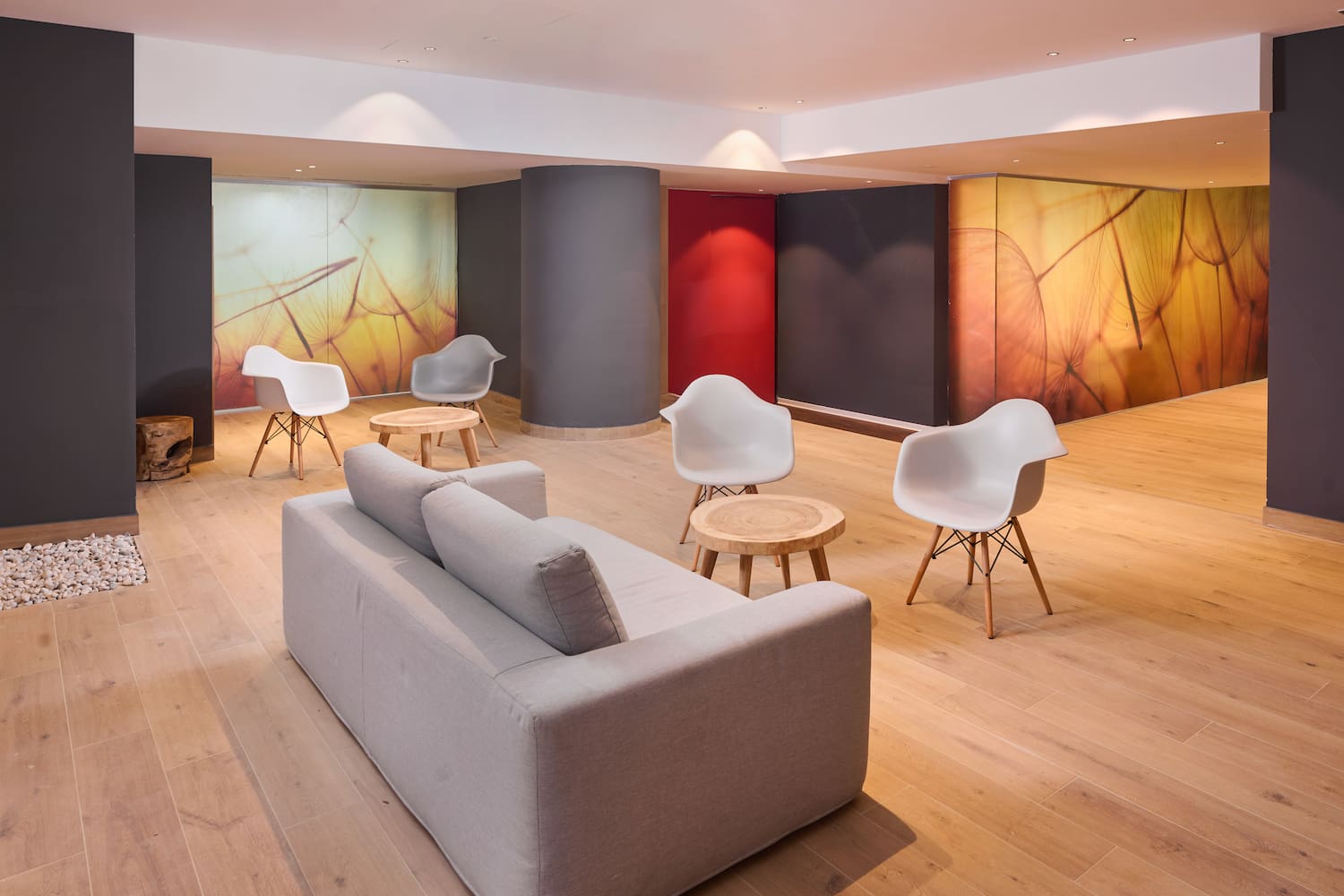 a room with a couch and chairs