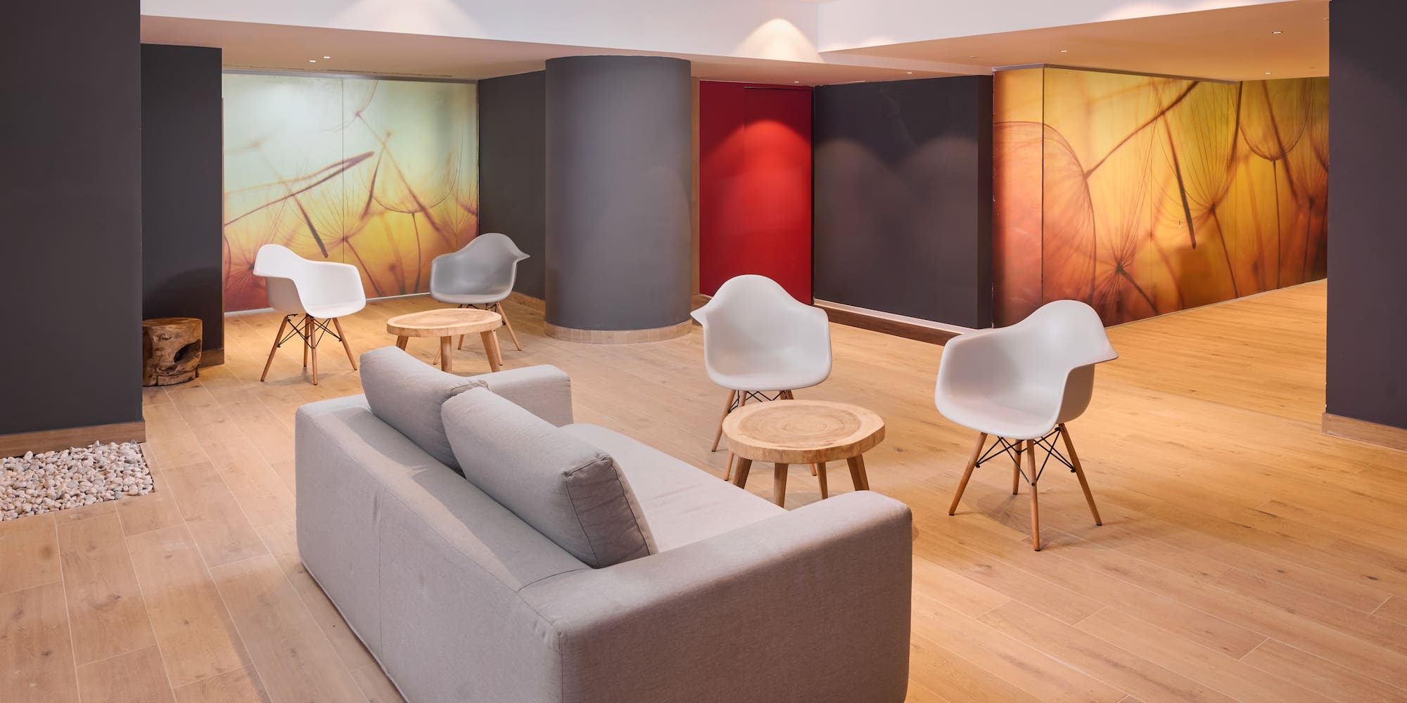 a room with a couch and chairs