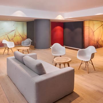 a room with a couch and chairs