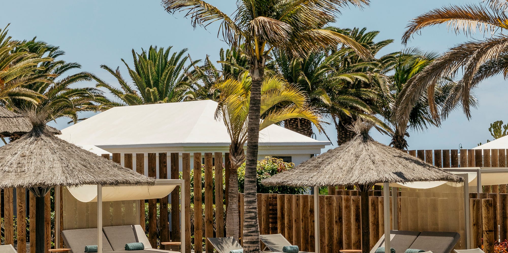 a pool with lounge chairs and umbrellas