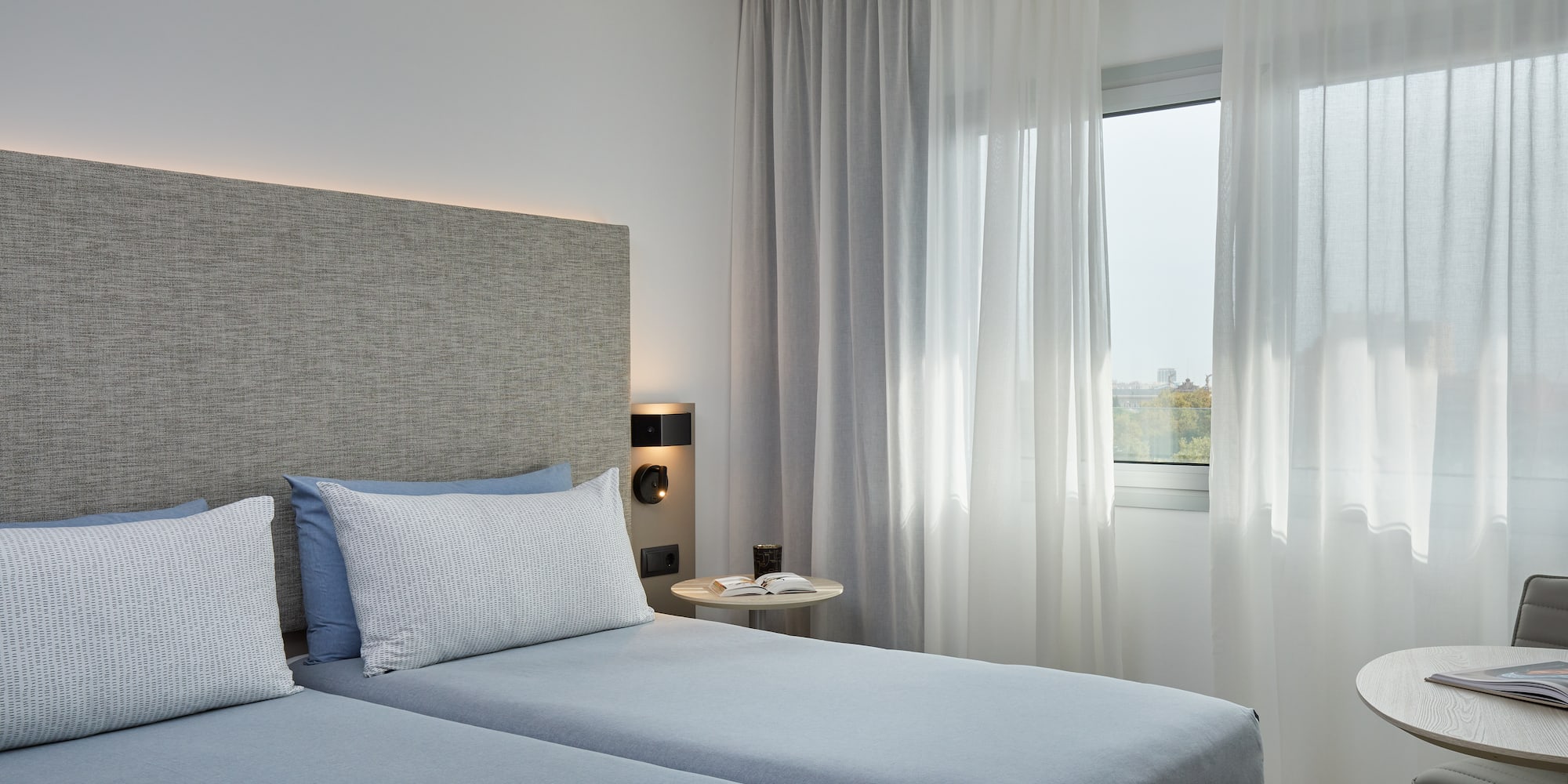 a bedroom with two beds and a window