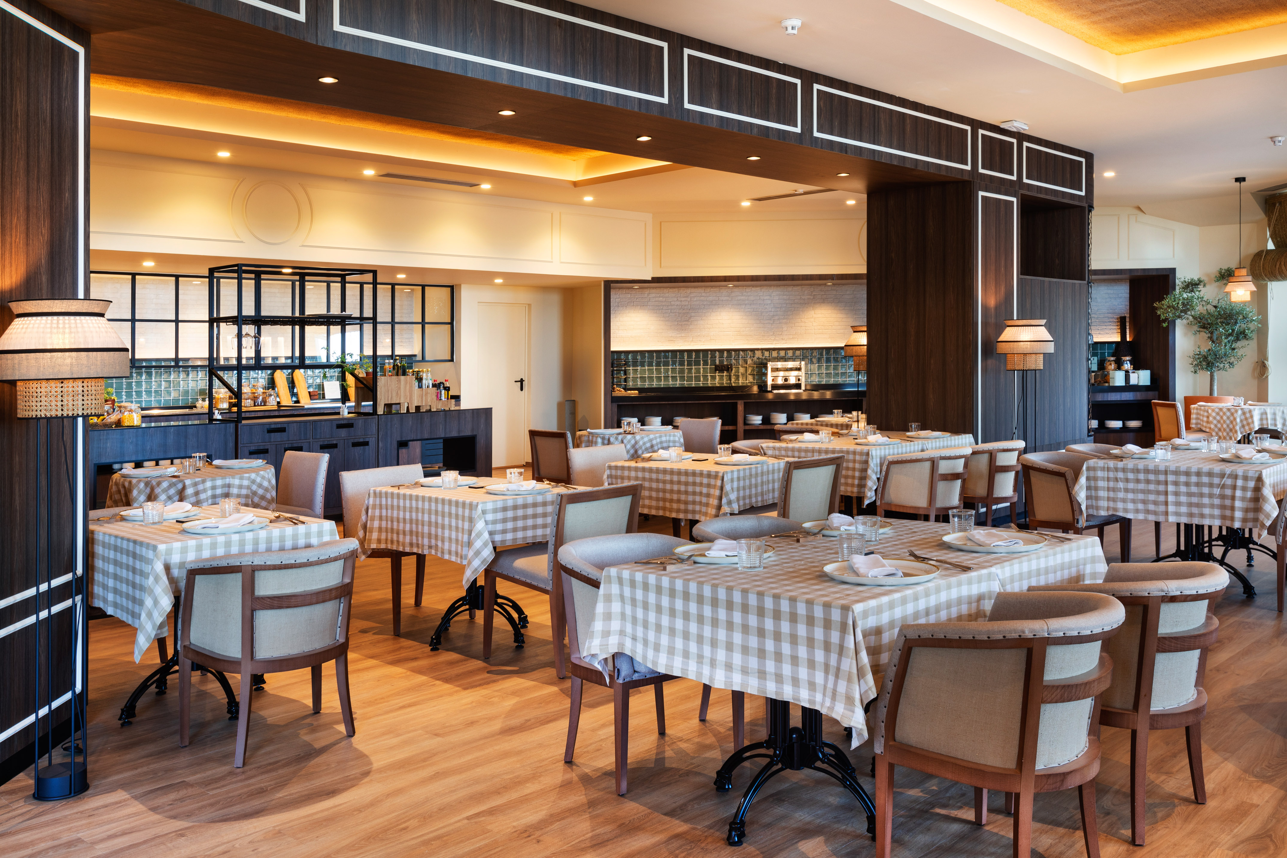 Elegant modern restaurant dining room with checkered tables and buffet area.