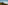 a mountain with a hill and clouds in the background