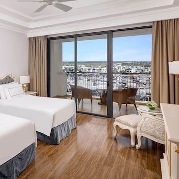 a room with two beds and a glass door