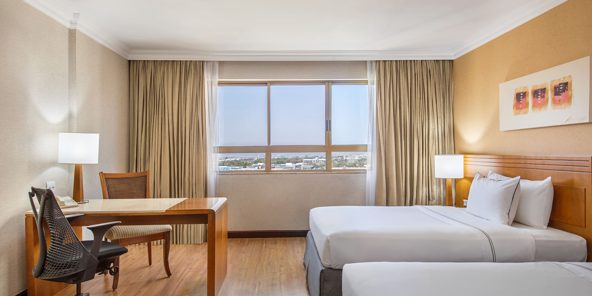 a room with two beds and a desk